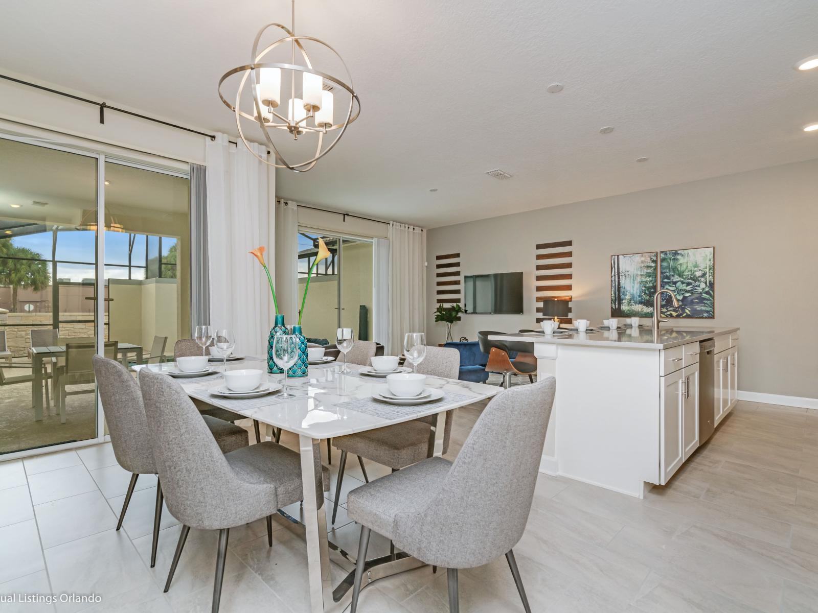 Chic Dining Area of the Townhouse in Kissimmee Florida - 6 Persons Dining - Open-concept design facilitates seamless flow between living, dining, and kitchen - Statement chandelier