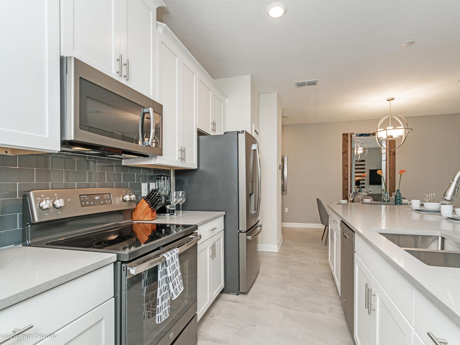 Polished Kitchen of the Townhouse in Kissimmee Florida - Functional layout designed for efficient meal preparation - Well-lit workspace with strategically placed task lighting - Integrated appliances for a seamless and stylish appearance