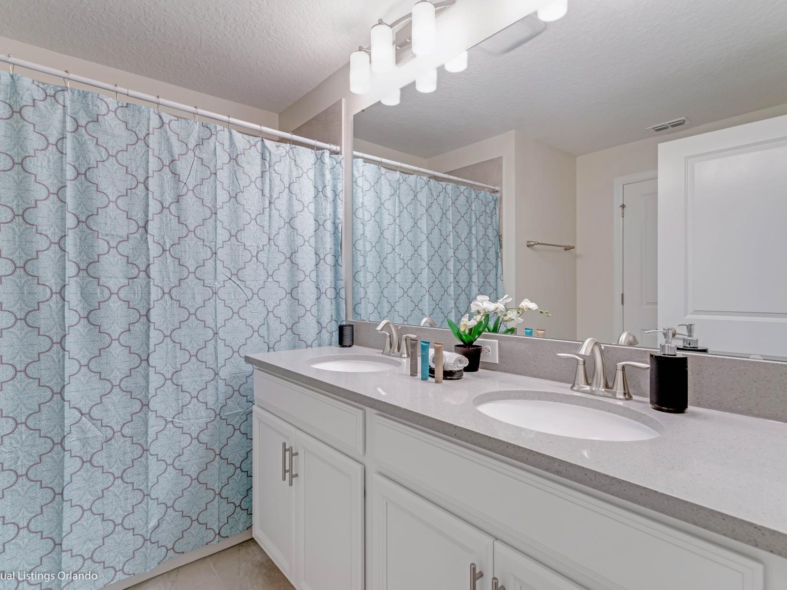 Eclat Bathroom of the Townhouse in Kissimmee Florida - Lush Dual Vanity with Large mirror - Superb bathtub with sliding curtains for added privacy