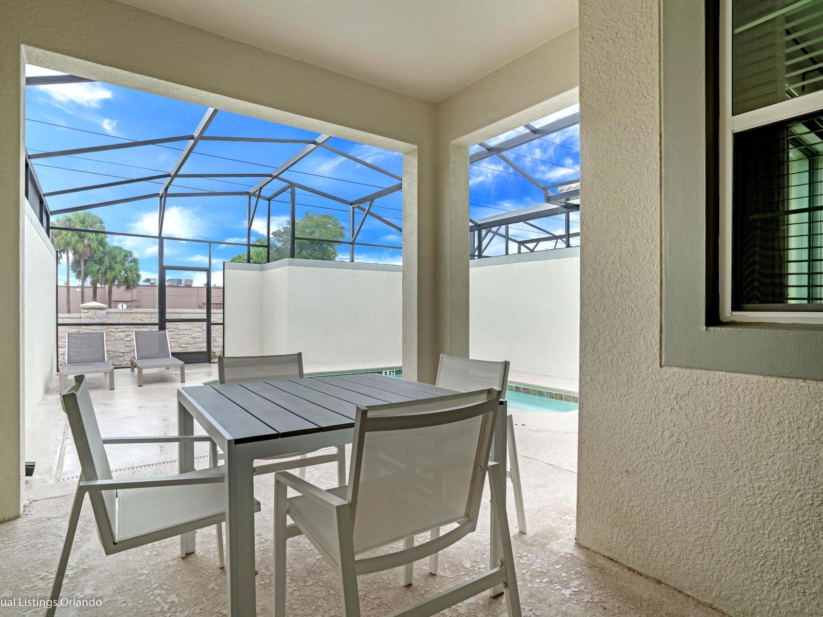 Refreshing Outdoor Dining of the Townhouse in Kissimmee Florida - Savor the flavors of paradise with a side of poolside serenity - Outdoor dining experience offers a feast for the senses - Every meal accompanied by stunning pool views