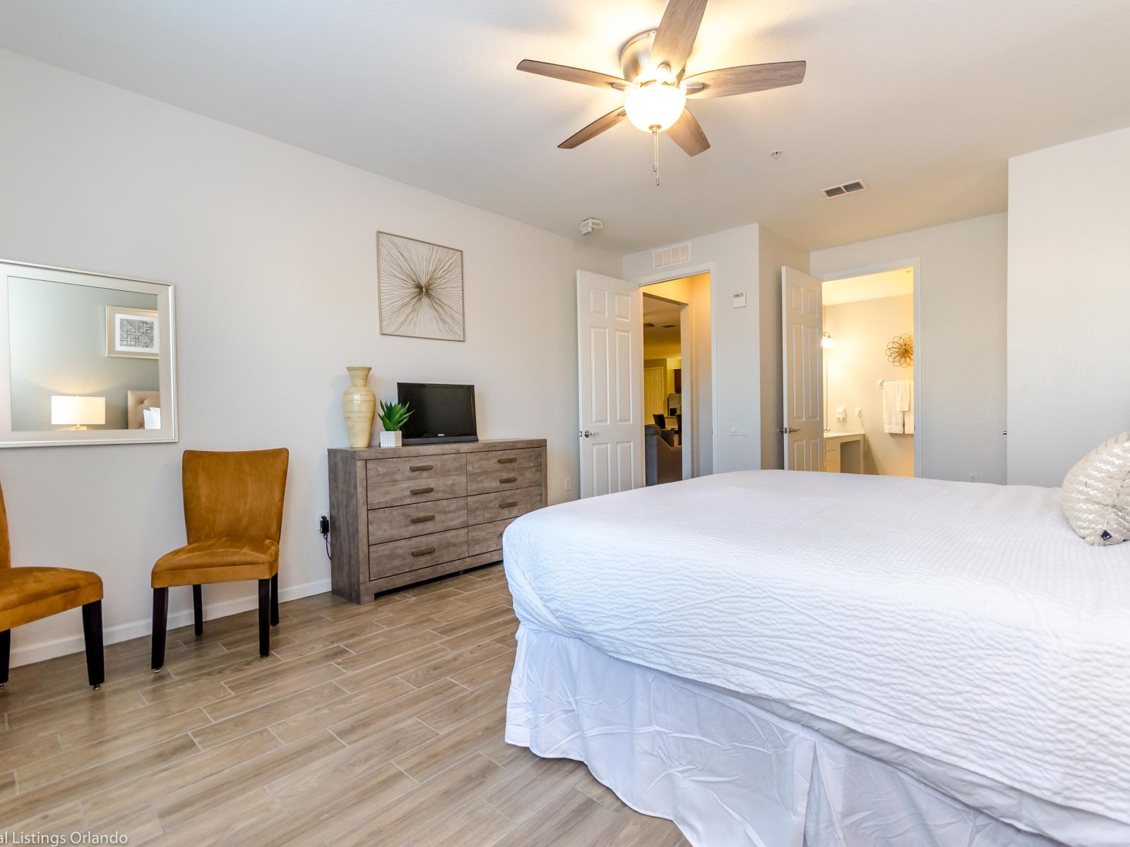 Discover the perfect blend of comfort and style in this bedroom, featuring two inviting accent chairs – where every corner is a cozy retreat and every detail is designed for relaxation and elegance.