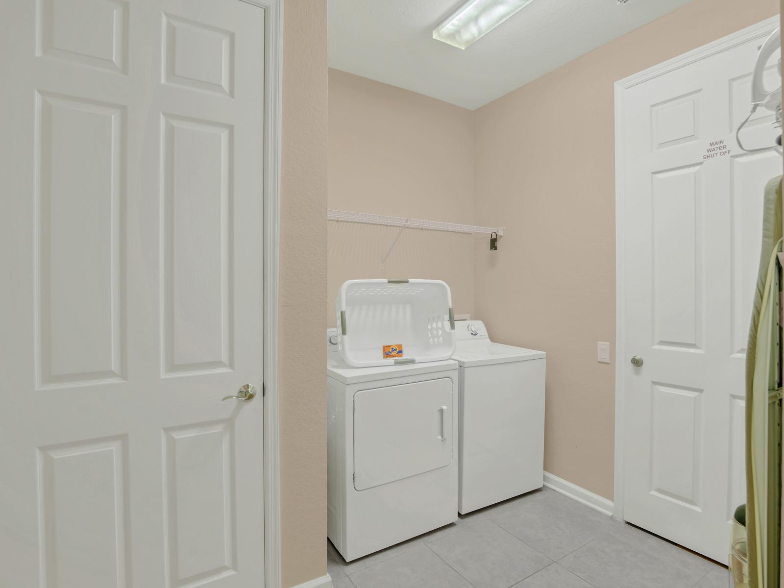 The laundry area boasts a full-size washer and dryer, ensuring that you can easily keep your clothes fresh and clean throughout your stay.