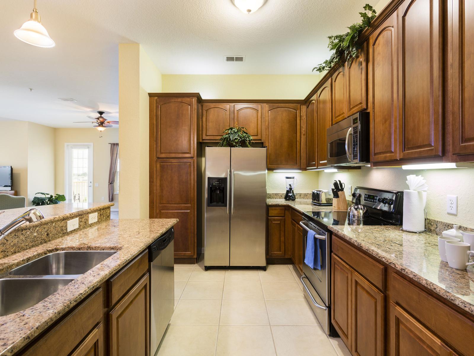 Exclusive and fully equipped kitchen of the condo in Orlando - Beautifully designed wardrobes throughout the kitchen area with sufficient storage space - All Kitchen accessories available - Availability of high chairs at the breakfast bar