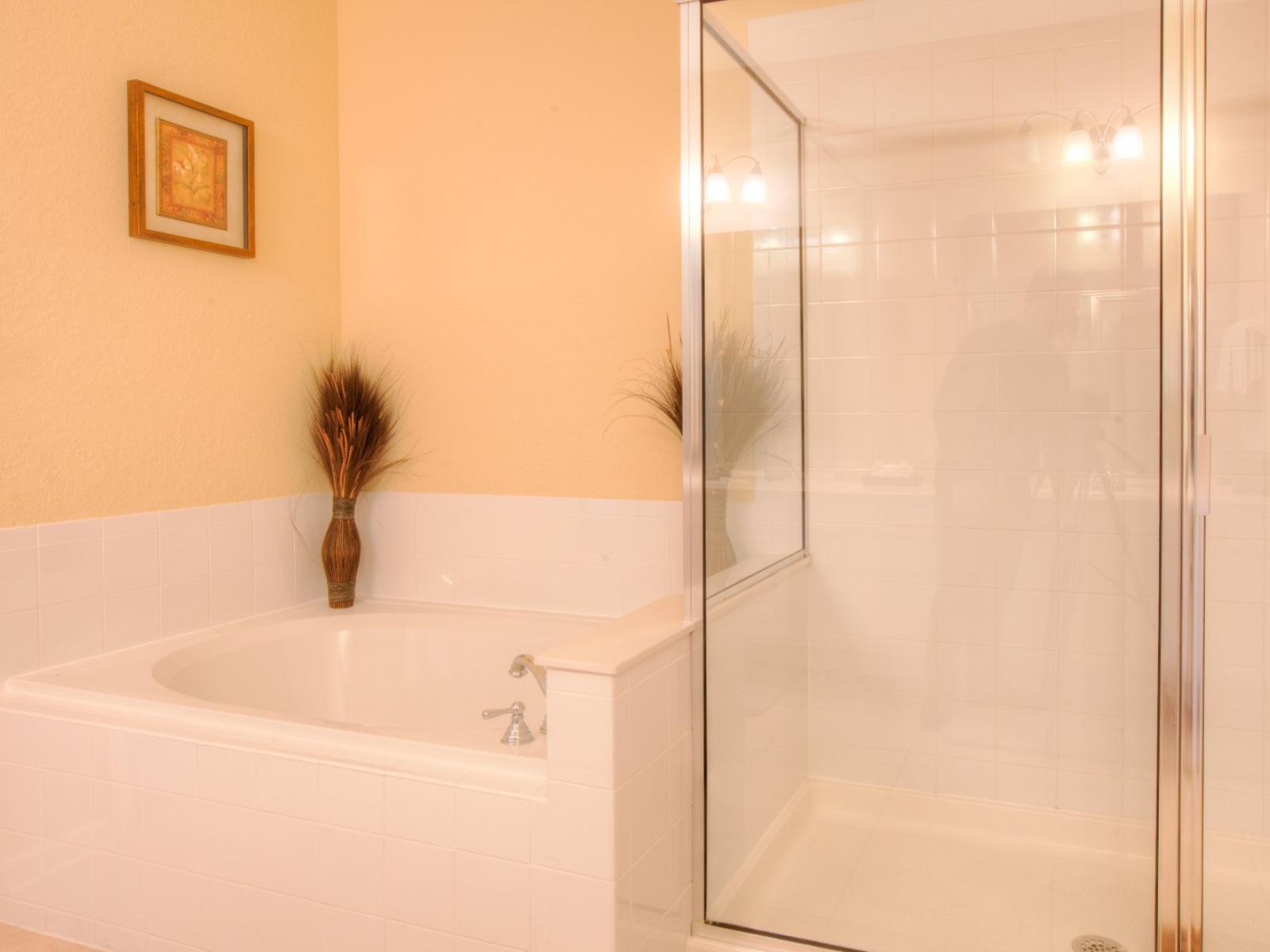 Step into the bathroom with its sleek shower enclosure and a bath tub, embodying modern comfort and style.