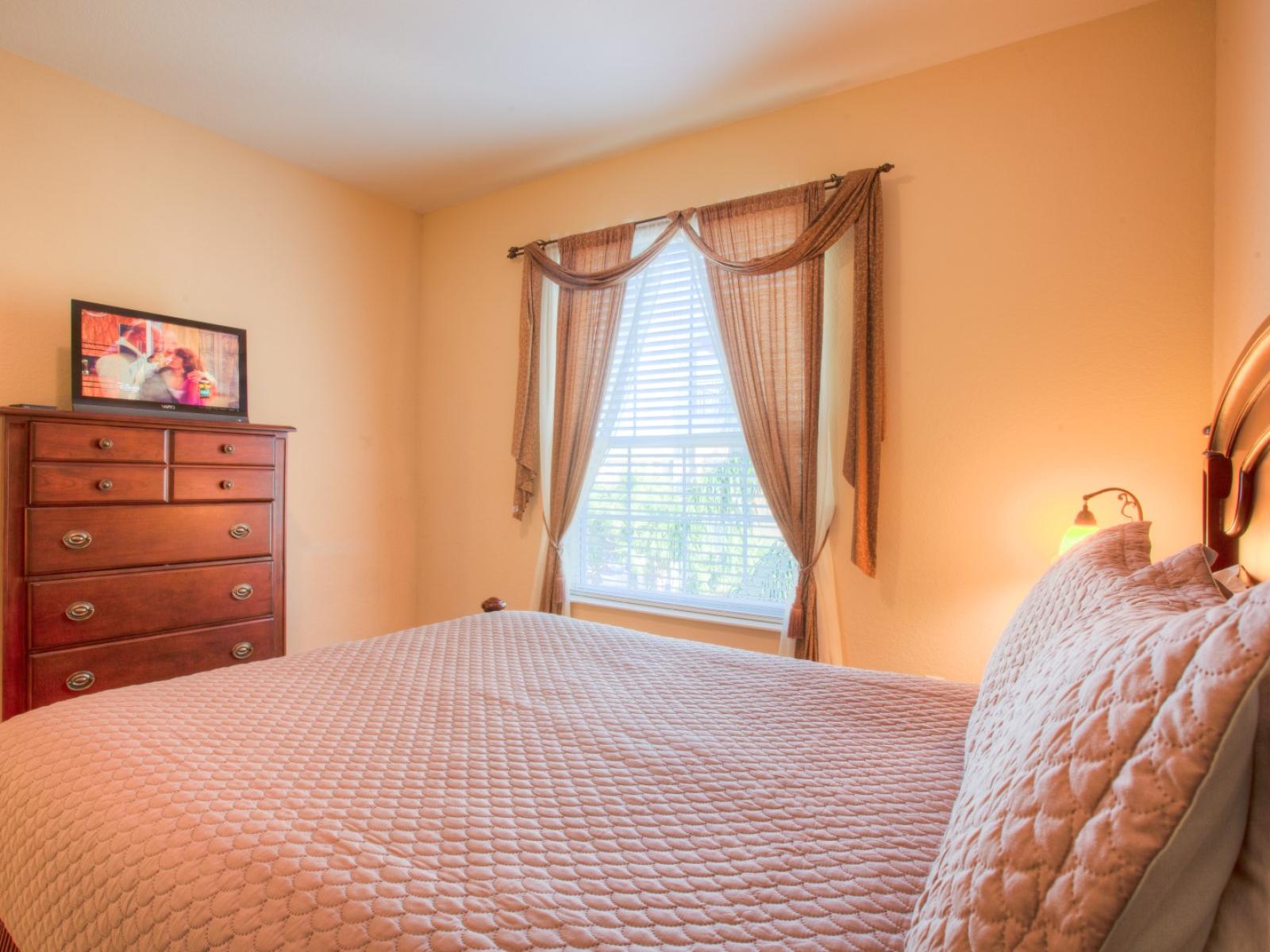 Experience vibrant comfort in this cozy bedroom, complete with a TV for your entertainment needs. Relax and unwind in style.