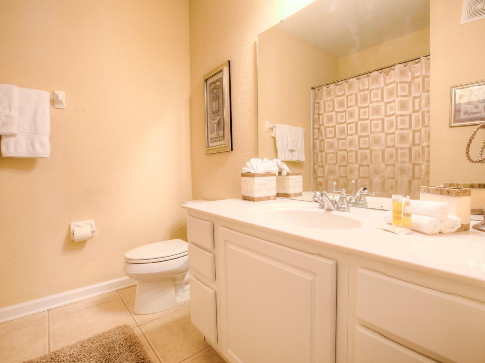 Enjoy a rejuvenating experience in the second bathroom, complete with a toilet and bath for your comfort and convenience.