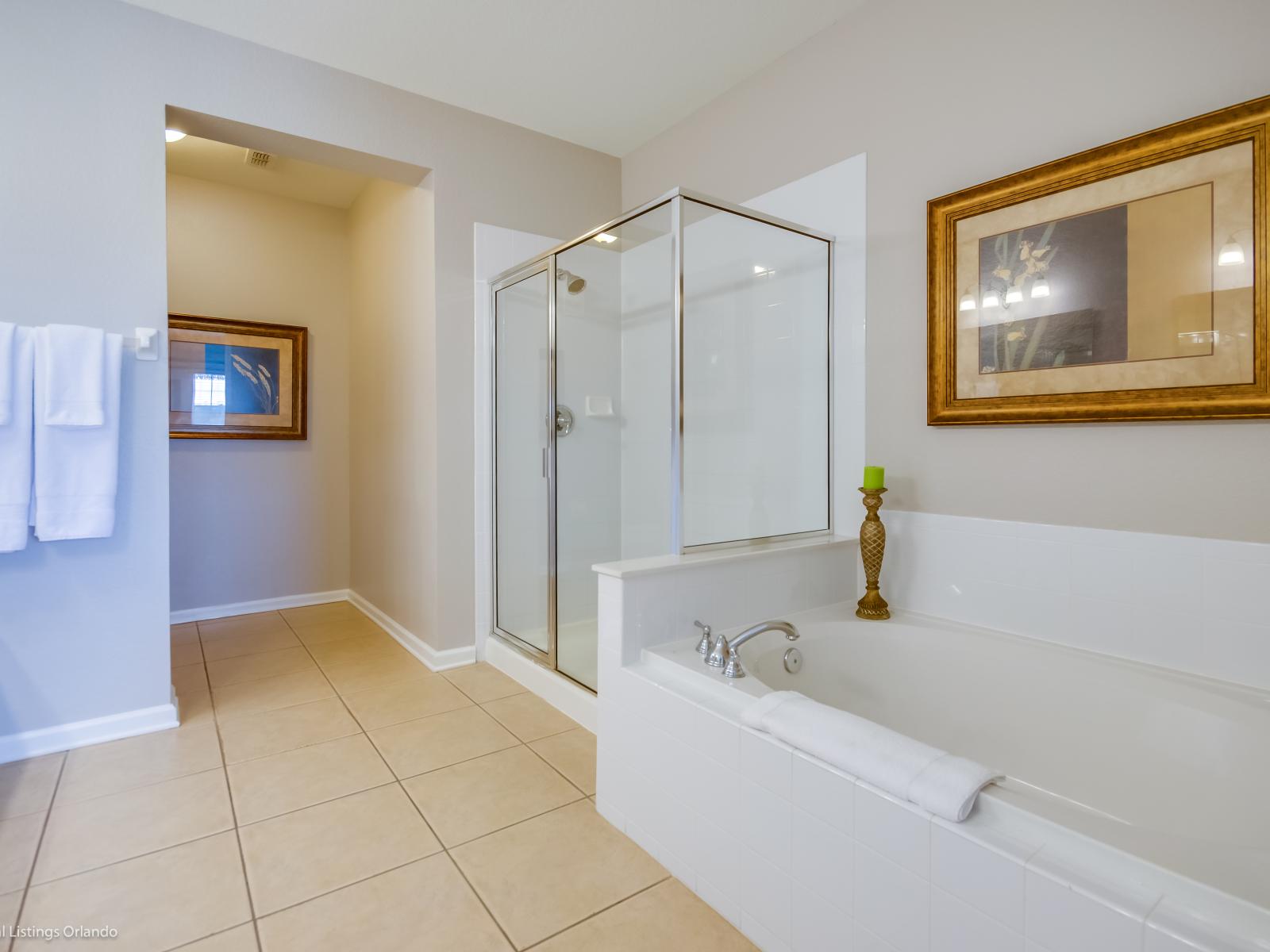 Featuring a sleek shower enclosure and a bath tub, offers a refreshing retreat where modern design meets functionality, providing a rejuvenating space to start and end the day.