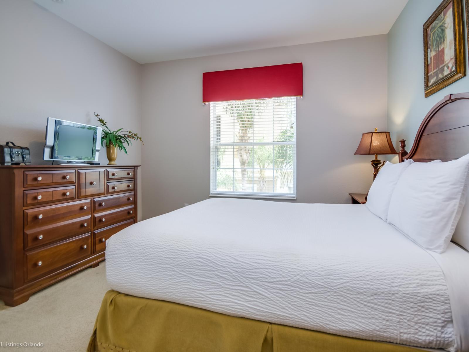 Experience vibrant comfort in this cozy bedroom, complete with a TV for your entertainment needs. Relax and unwind in style.