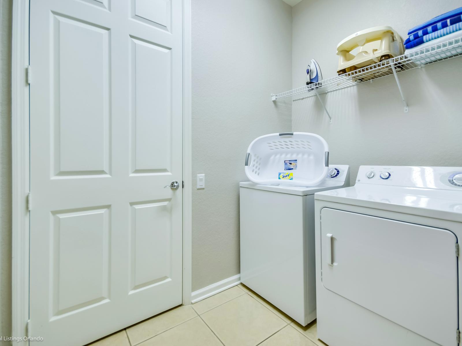 The laundry area boasts a full-size washer and dryer, ensuring that you can easily keep your clothes fresh and clean throughout your stay.