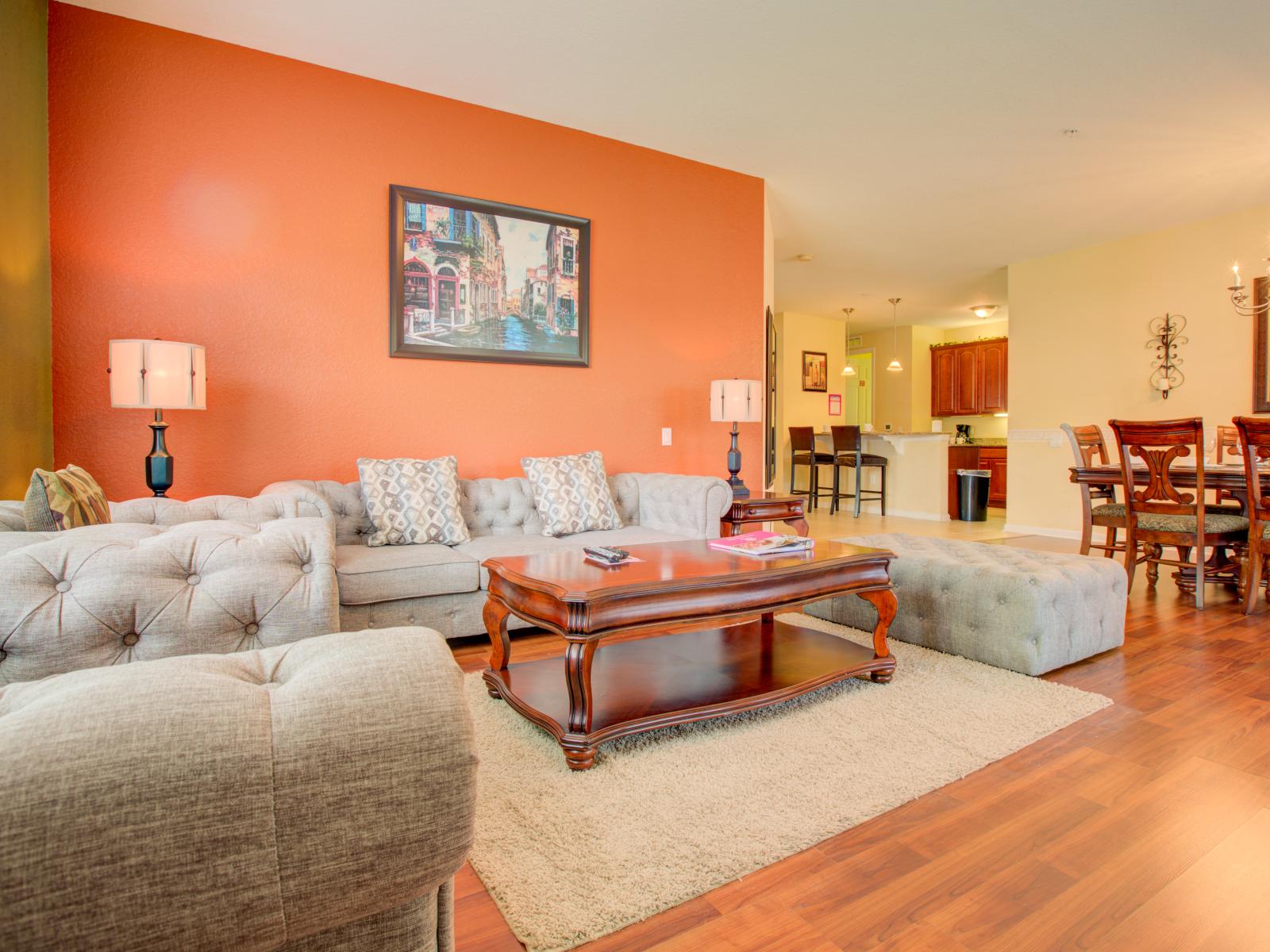 Rustic living area of the condo in Orlando - Where elegance meets modern comfort. - Marvelously arranged cozy sofas to relax - Wooden furnished floor - Decored with majestic wall painting - Elegant space with smooth lighting