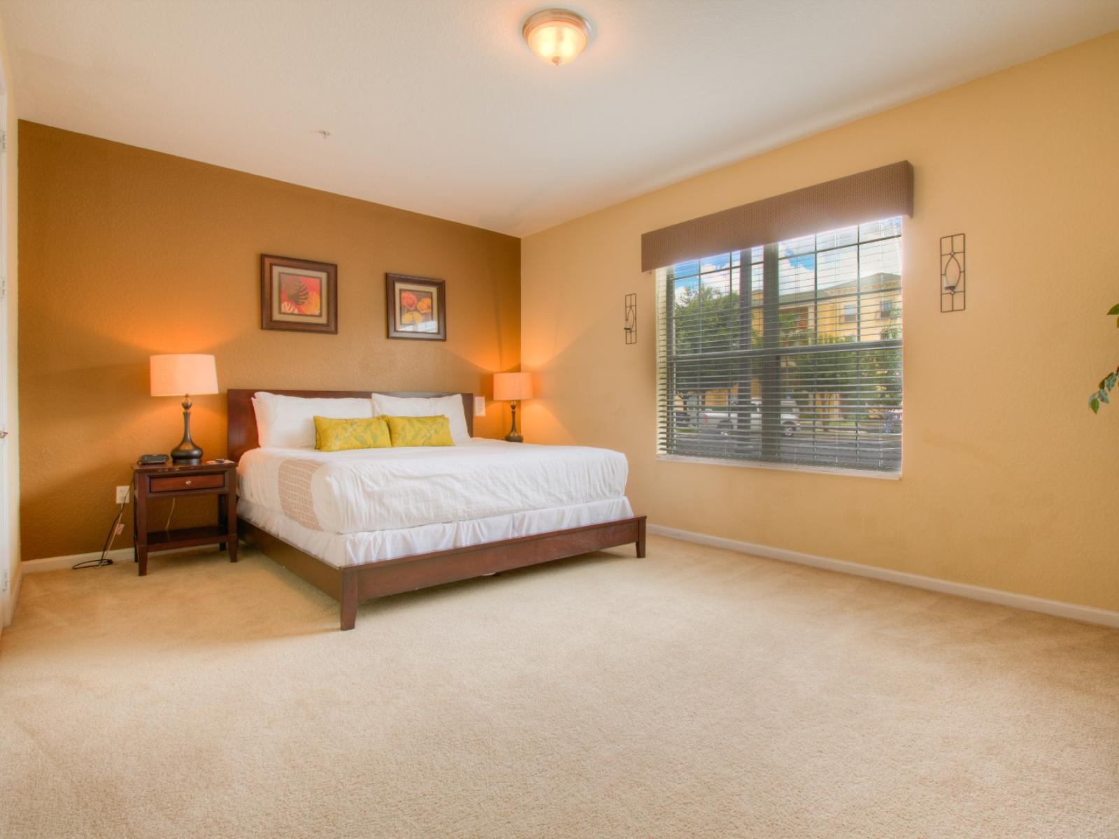 Exclusive bedroom of the condo in Orlando - It offers a cozy king size with with neat and clean linen and fluffy pillows - Enjoy restful nights in a relaxing and lavish ambiance - Thoughtfully appointed bedside window with outside views