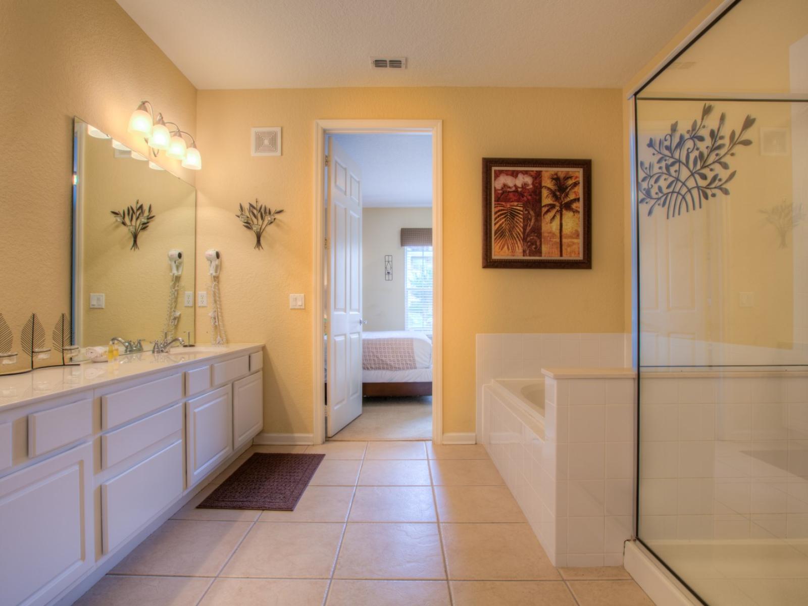 Classy bathroom of the condo in Orlando - Immerse yourself in the beauty of artistic expression in this vanity area - Fresh up yourself in a cozy bathtub or a glass enclosed shower area - Experience the refreshing ambiance