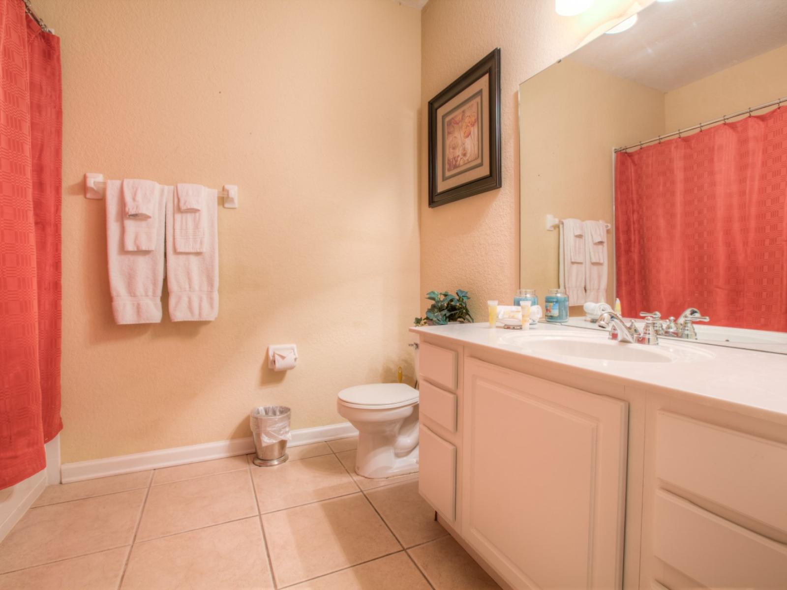 A  harmonious blend of a serene toilet and bath with an elegant vanity area. Elevate your self-care routine in this stylish sanctuary.