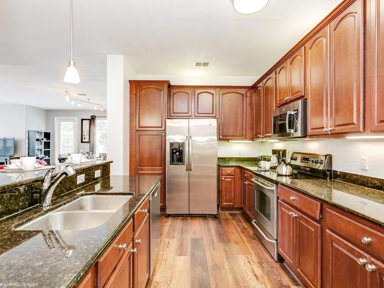 Stylish open kitchen of the condo in Orlando - With sleek counter table tops and high chairs - Offering a modern and welcoming space for both cooking and dining. - Fully equipped with all kitchen accessories - Excellent bright space