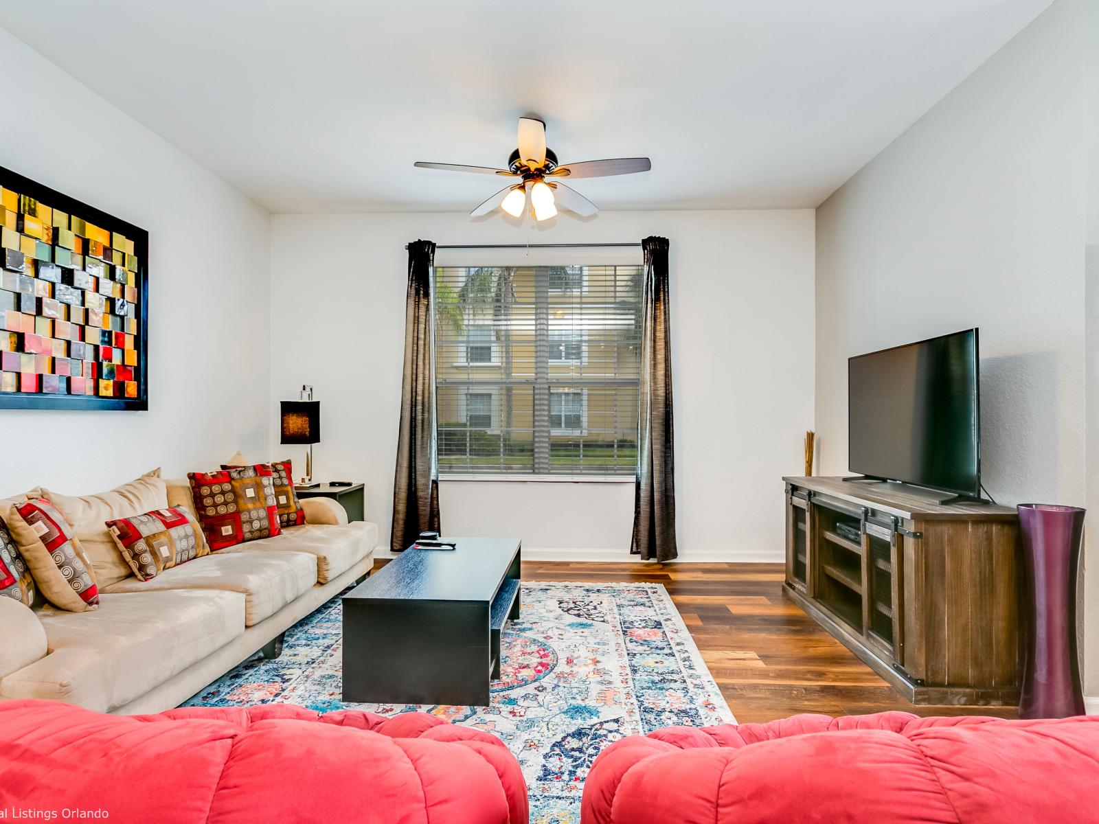 Glamorous living area of the condo in Orlando - Cozy and well organized sofas to sit while having a gathering - Lush Views from the well appointed window in the living area - Availability of Smart Tv and Netflix for your night entertainment