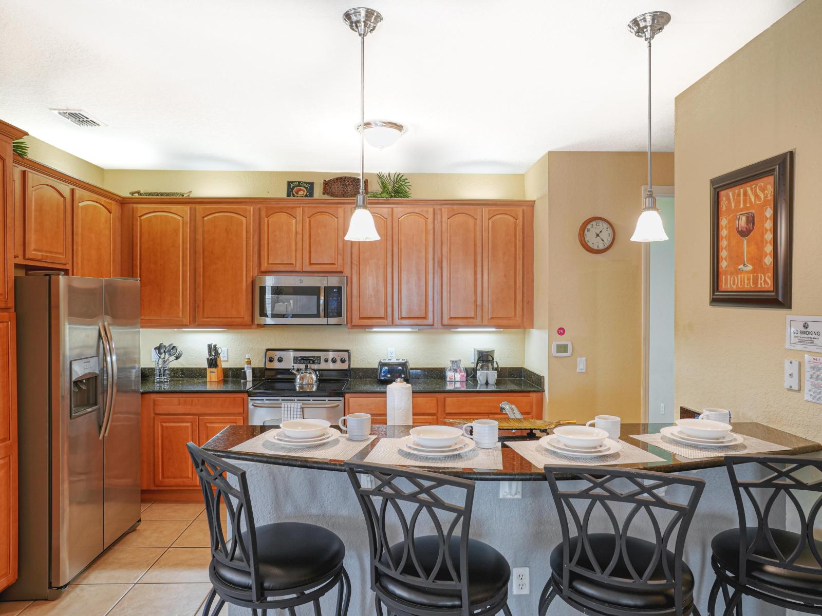 The fully equipped kitchen with a breakfast bar combines modern functionality with a touch of elegance, offering guests a delightful space to create and enjoy delicious meals in the comfort of their home away from home.