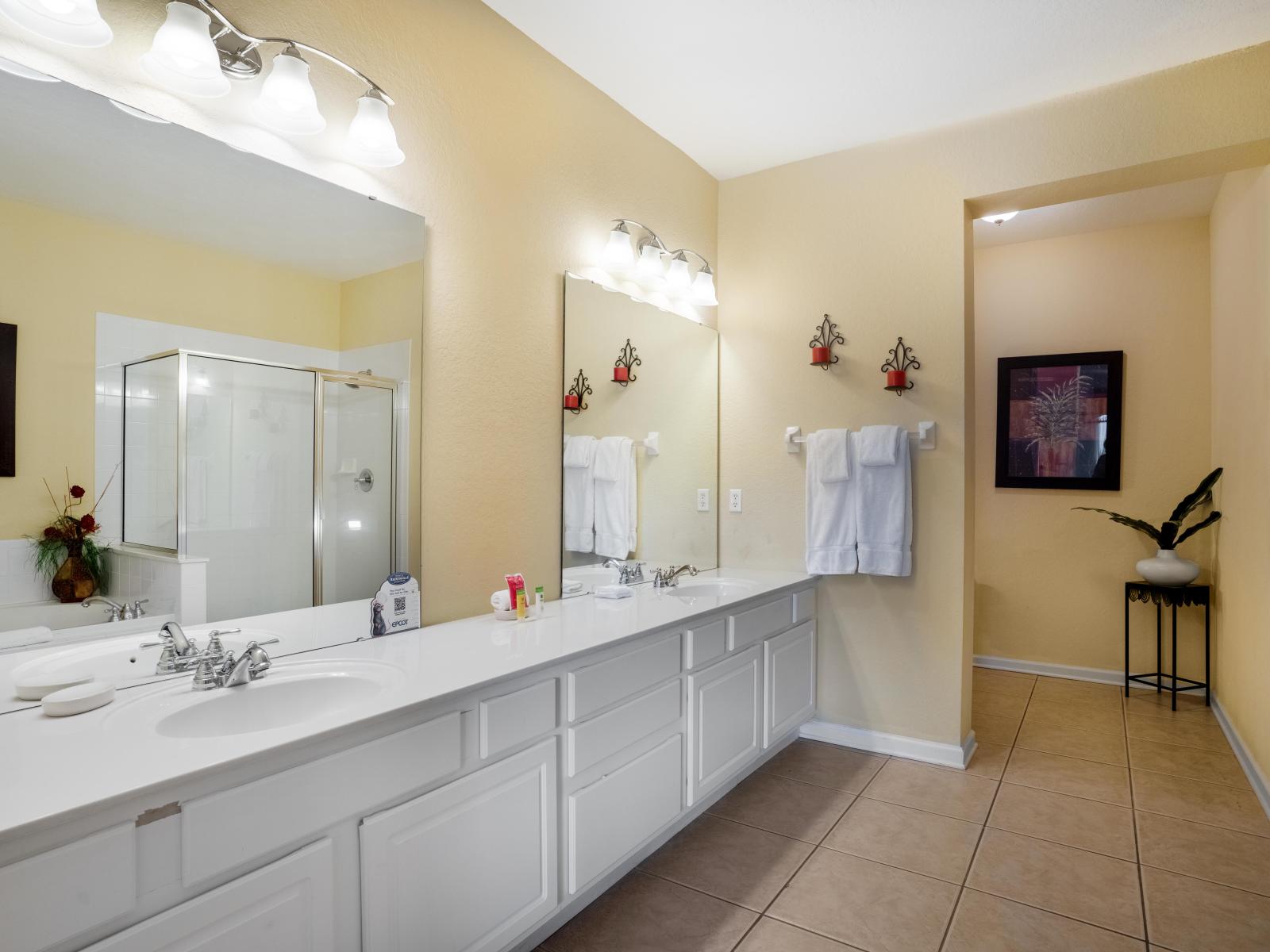 Refined Grooming Space: The bathroom includes a vanity area, offering guests a stylish and well-lit space for grooming and preparing for the day, adding a touch of luxury to their stay.