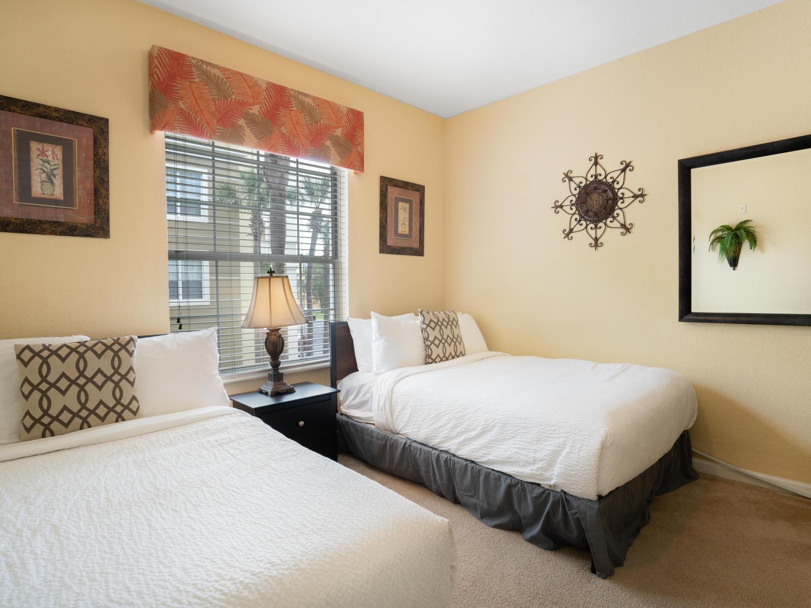 Relax and unwind in our inviting bedroom with two beds. Perfect for families or friends traveling together, this cozy space offers double the comfort for a restful night's sleep.