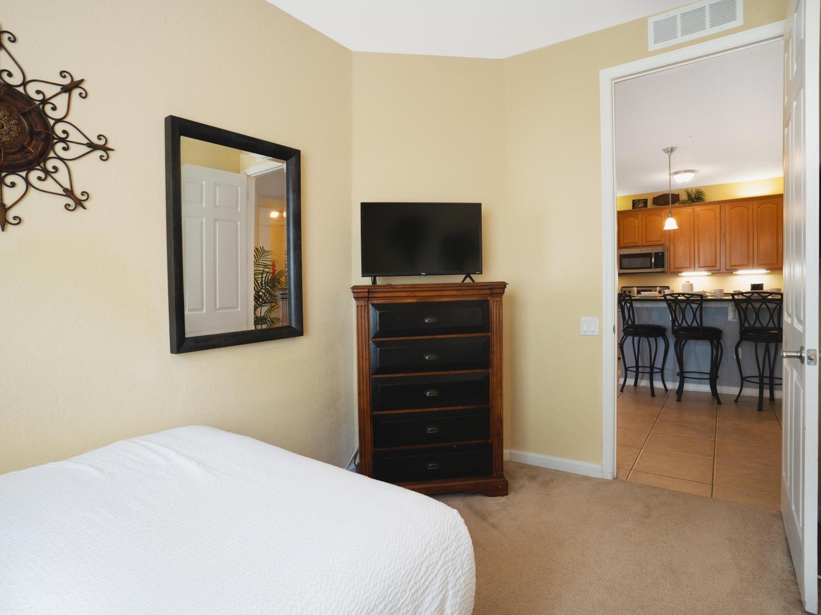 Entertainment Oasis: Retreat to this cozy bedroom adorned with a TV, offering the perfect escape for relaxation and leisure.