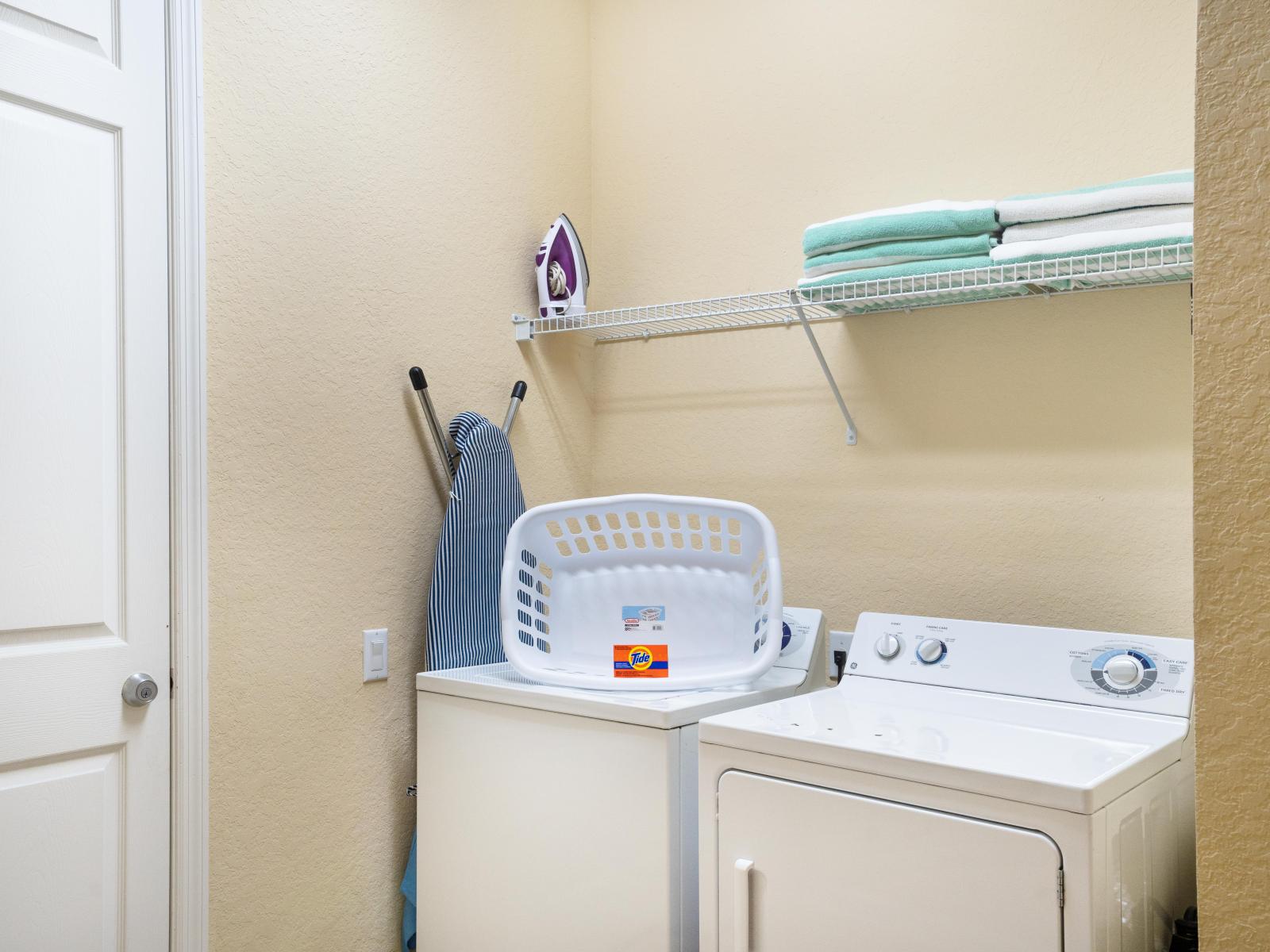 The laundry area boasts a full-size washer and dryer, ensuring that you can easily keep your clothes fresh and clean throughout your stay.