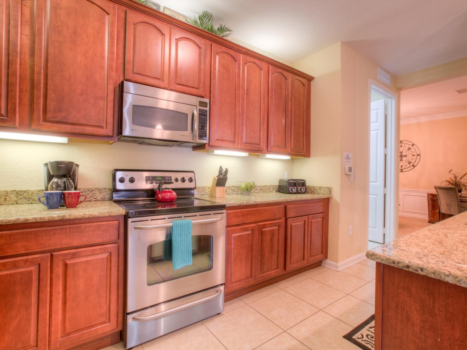 Step into our fully equipped kitchen of the condo in Orlando - Designed to inspire your inner chef with its modern amenities and sleek design - Admire the architectural charm of our wooden work in the kitchen - Plenty of storage space