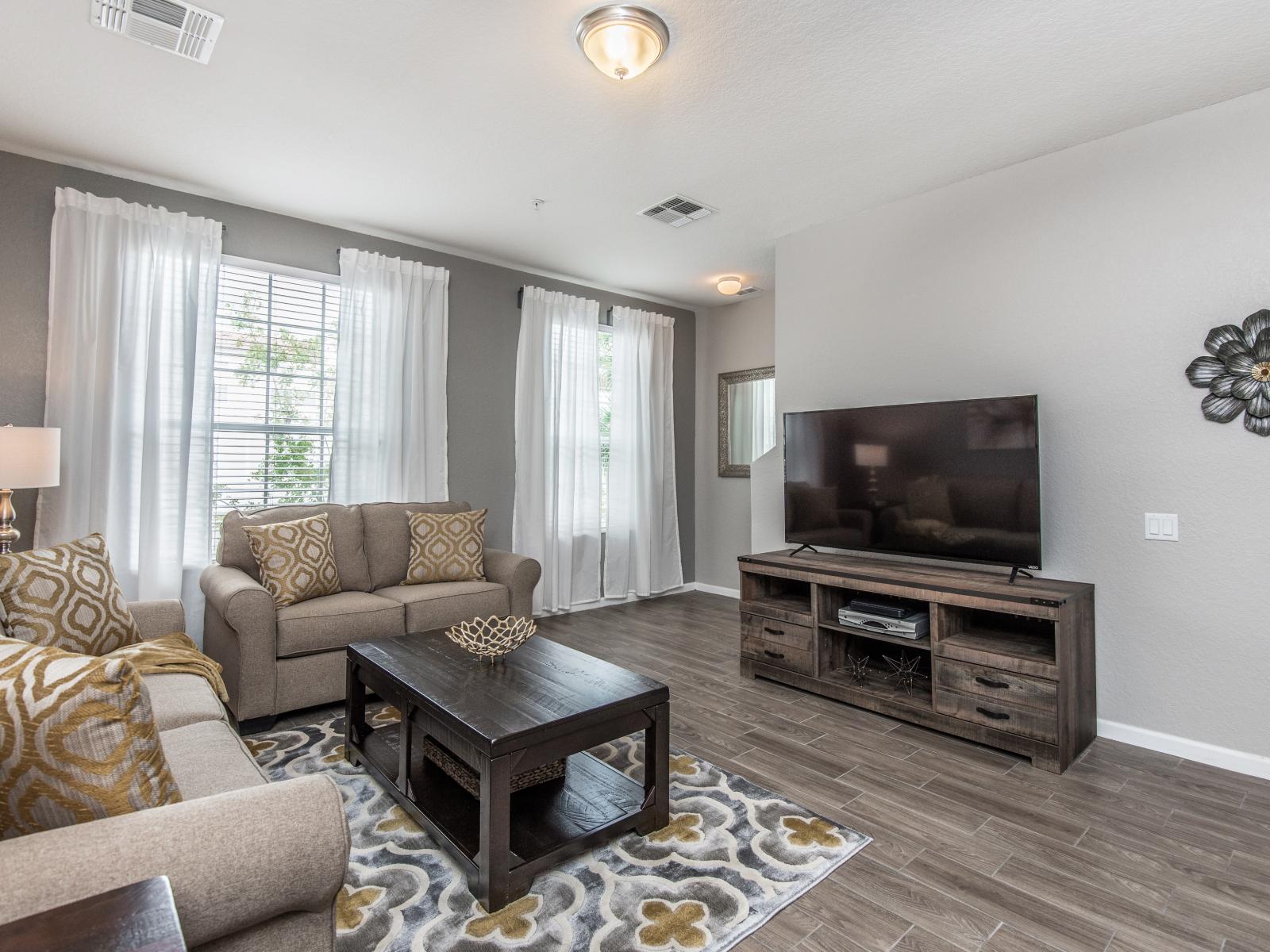 Serene Living Space with a View: Admire the scenic beauty through large windows while lounging in the tranquility of our thoughtfully decorated living room