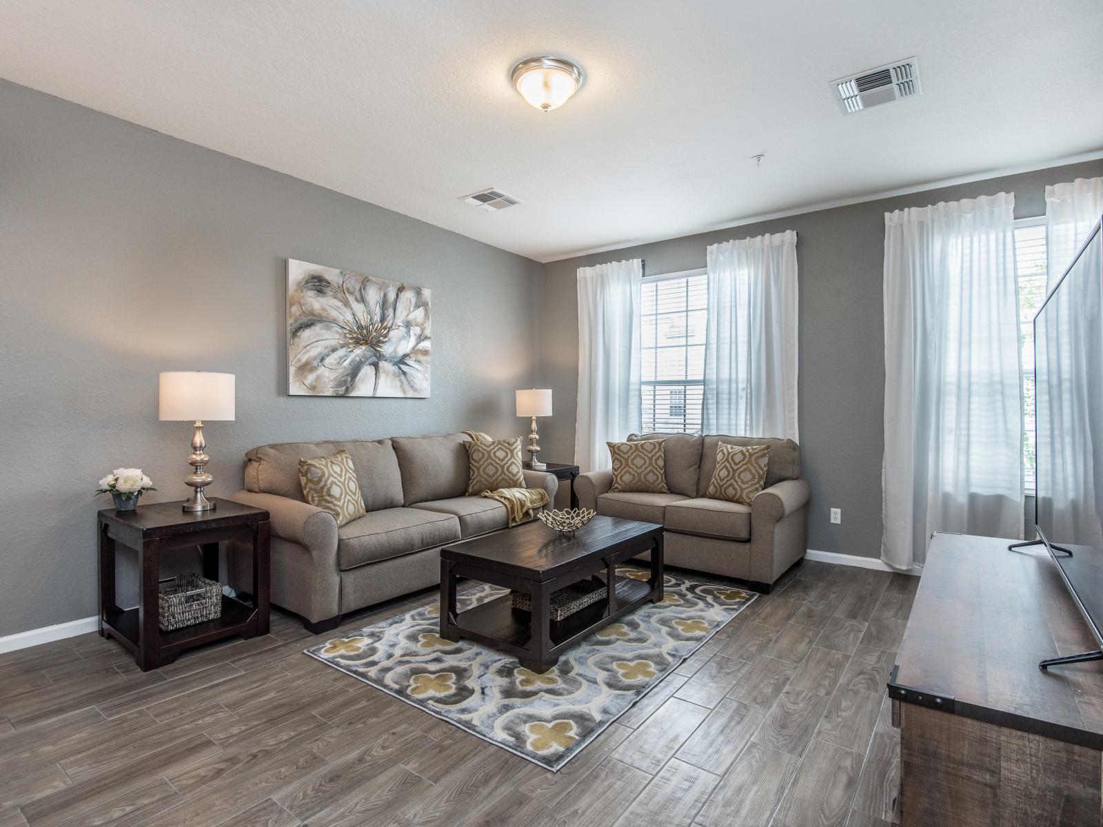 Serene Living Space with a View: Admire the scenic beauty through large windows while lounging in the tranquility of our thoughtfully decorated living room