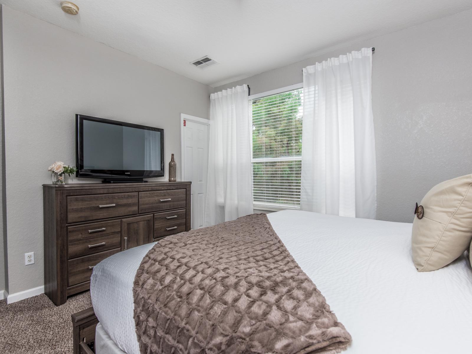 This bedroom radiates warmth and serenity, inviting you to unwind in a cozy retreat where nature's embrace meets modern comfort.