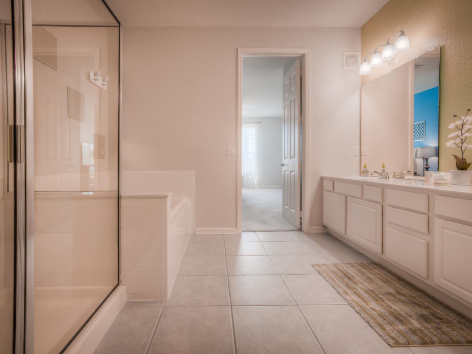 Experience the elegance of our classy bathroom of the condo in Orlando - Complete with a soothing bathtub and glass enclosed shower area for the ultimate comfort - Glorious vanity big size wall mirror and focus lamps - Fresh towels available