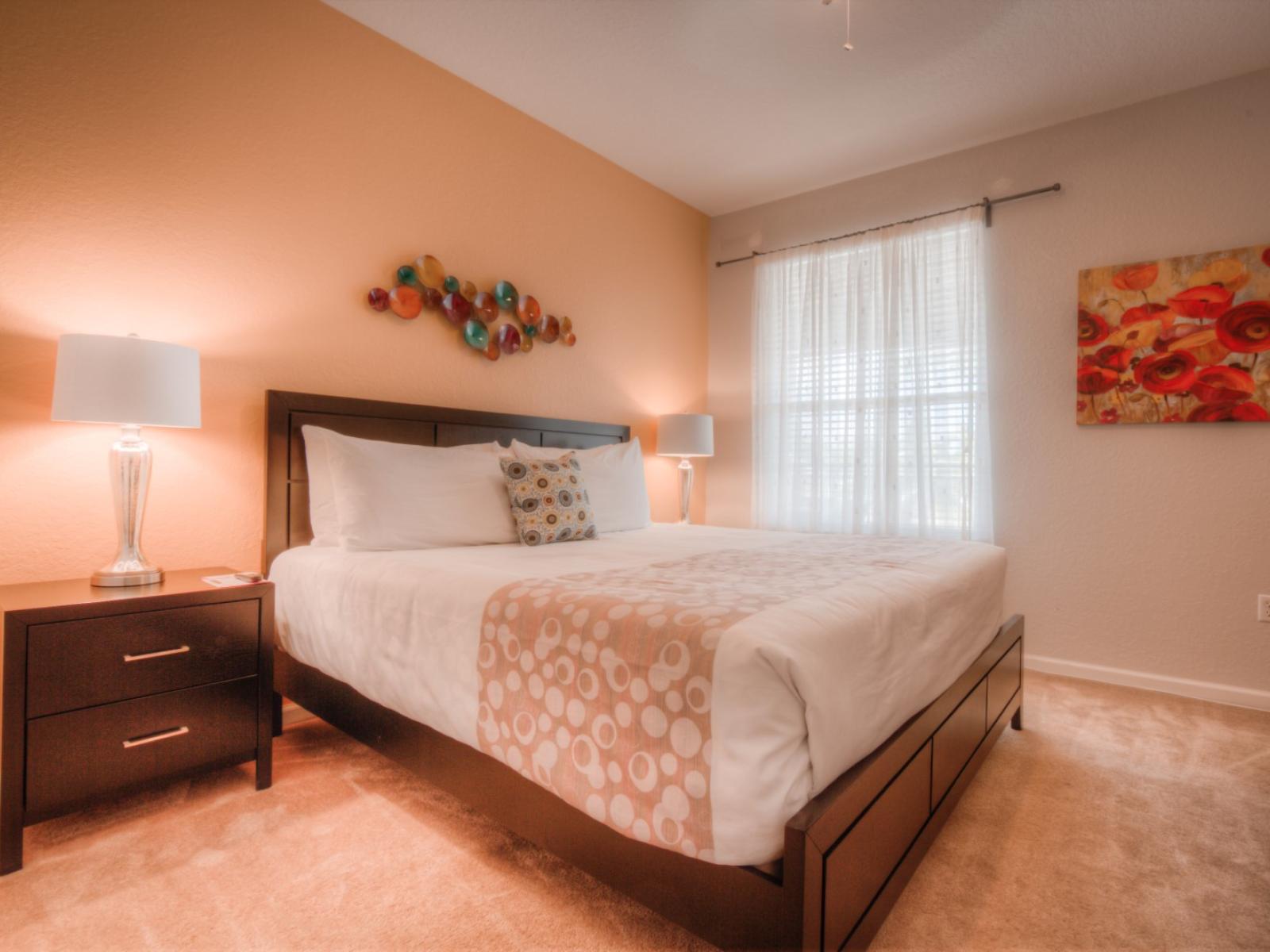 Tranquil bedroom of the condo in Orlando - Featuring king size cozy bed for peaceful and restful night's sleep - Stunningly carpeted floor - Majestic table lamps and beautiful paintings for the decoration - Neat and clean linen with soft pillows