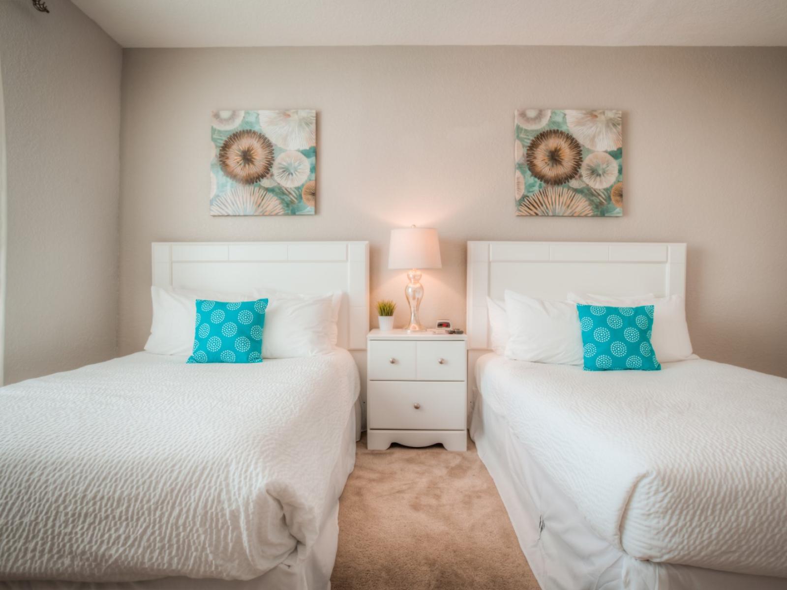 Welcome to the spacious two-bed bedroom at Vista Cay Resort, where relaxation meets style, providing guests with a cozy retreat to unwind and recharge amidst modern comforts and inviting ambiance.