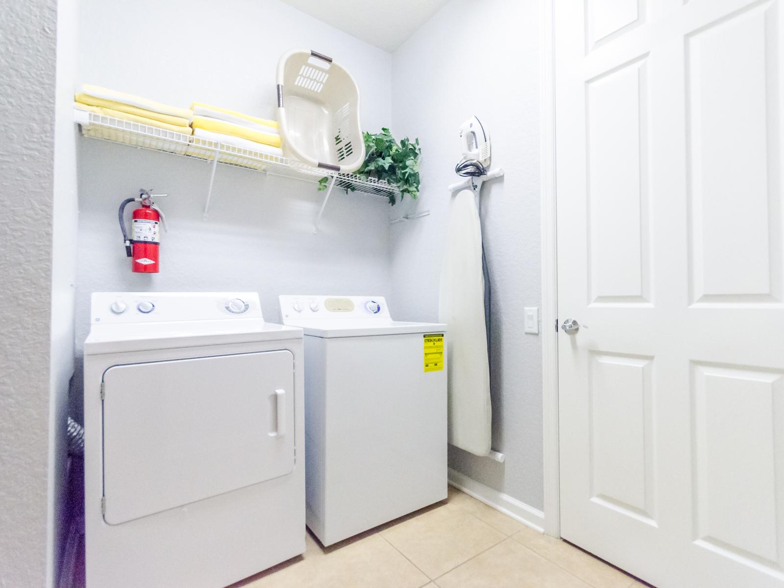 The laundry area boasts a full-size washer and dryer, ensuring that you can easily keep your clothes fresh and clean throughout your stay.