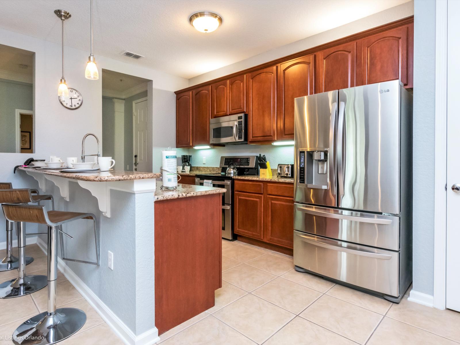 Sleek and Functional: Experience the best of both worlds in our Airbnb condo – a fully furnished, open-concept kitchen that blends style and practicality effortlessly.