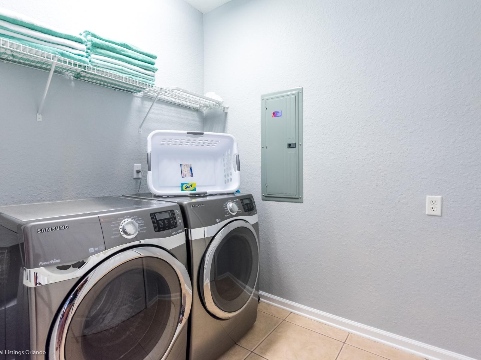 The laundry area boasts a full-size washer and dryer, ensuring that you can easily keep your clothes fresh and clean throughout your stay.