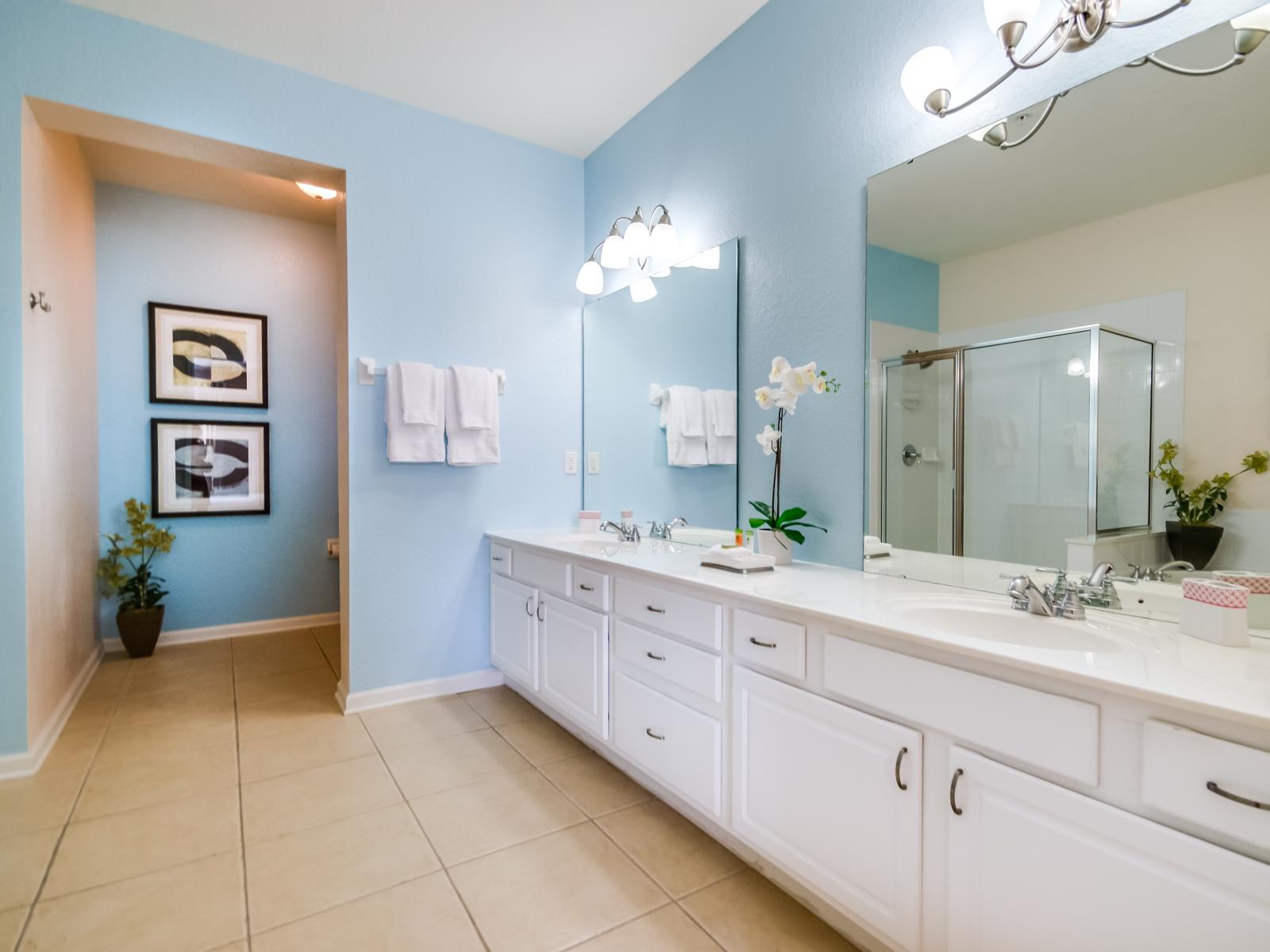 Exclusive bathroom of the condo in Orlando - Glorious vanity with twin sinks and twin wall mirrors - Sufficient storage space - Neat and fresh towels available - Amazingly decored bathroom with refreshing atmosphere