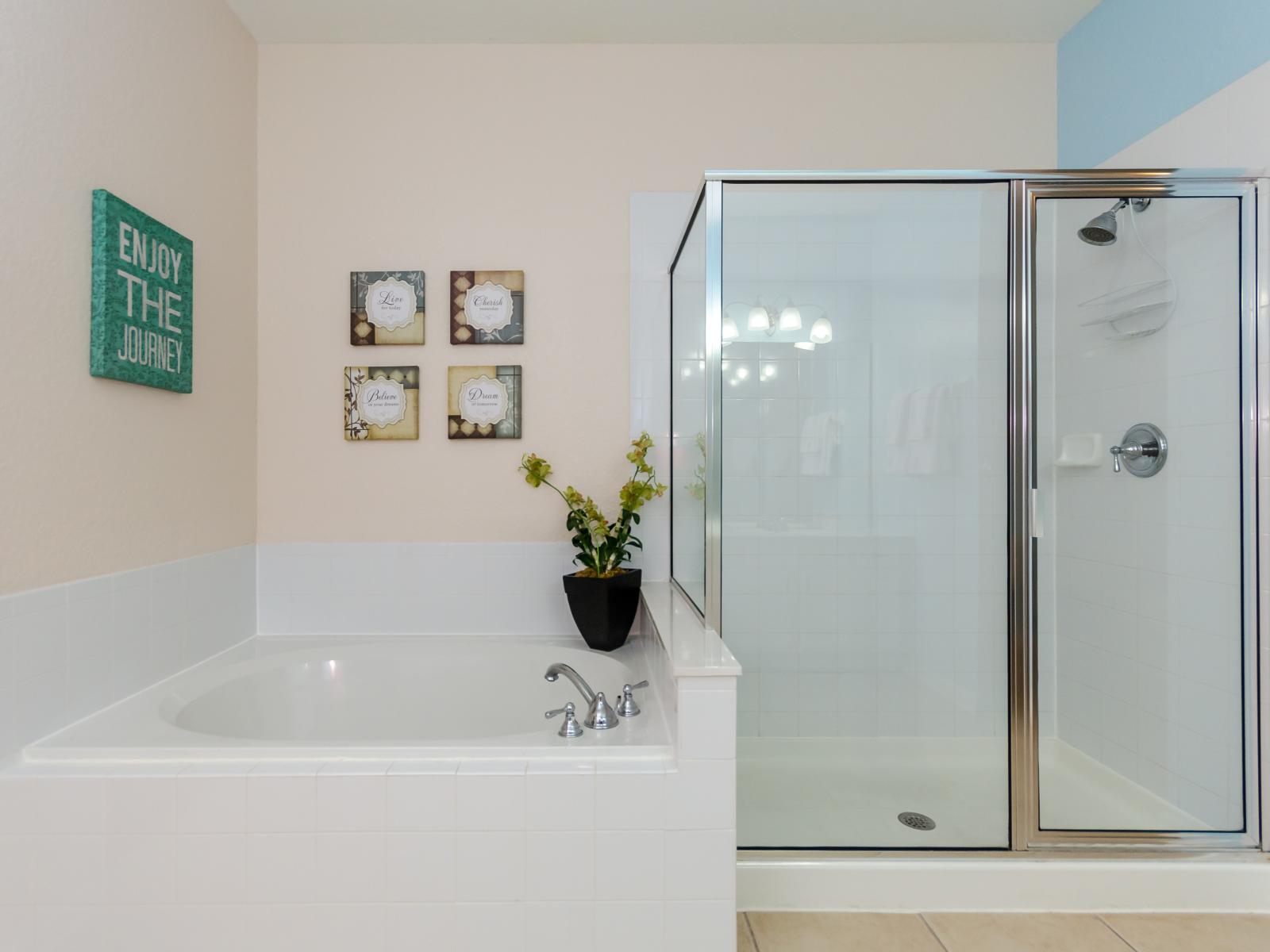 Indulge in relaxation with a luxurious bath tub and a sleek shower enclosure of the bathroom in Orlando - Creating a spa-like experience. - Well Decored space creating a refreshing ambiance