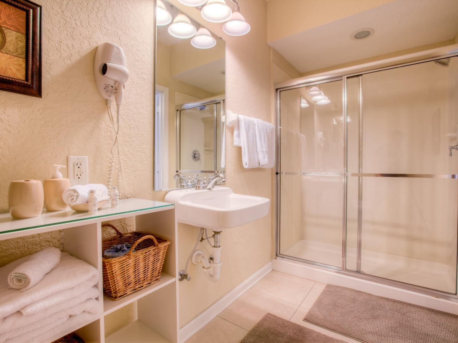 Enjoy a good hot bath in this very inviting and spotless bathroom with walk-in shower.