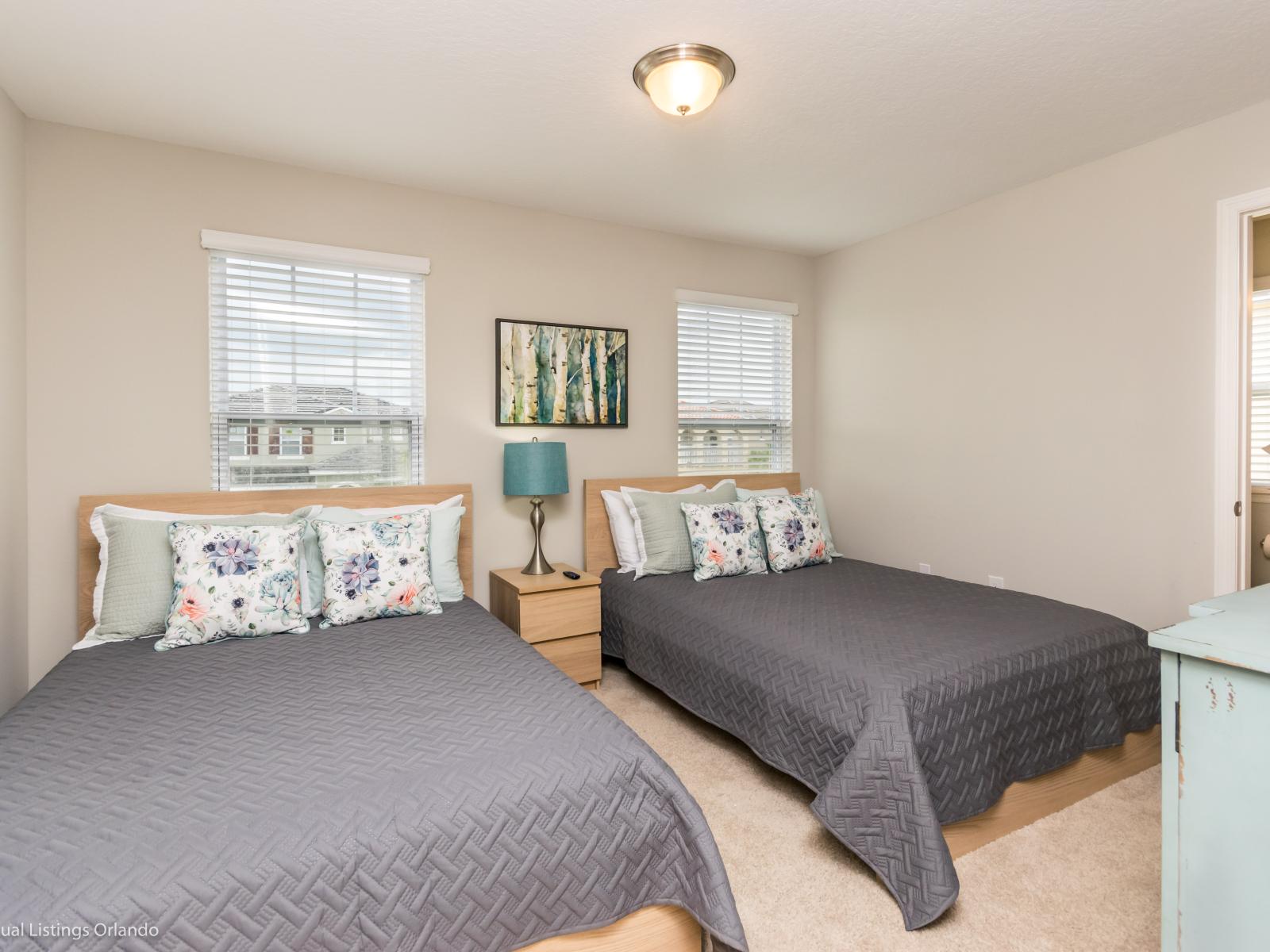 Tranquil bedroom of the home in Davenport Florida - Twin beds and tasteful decor create a peaceful retreat - Luxurious bedding for a restful night's sleep