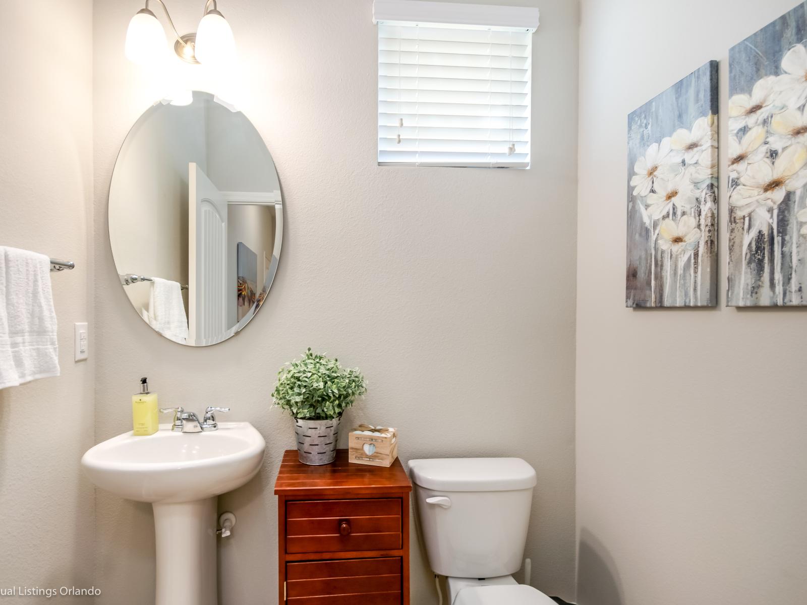 Clean half bathroom of the home in Davenport Florida - Bathroom adorned with elegant fixtures - Neat and clean toilet seat