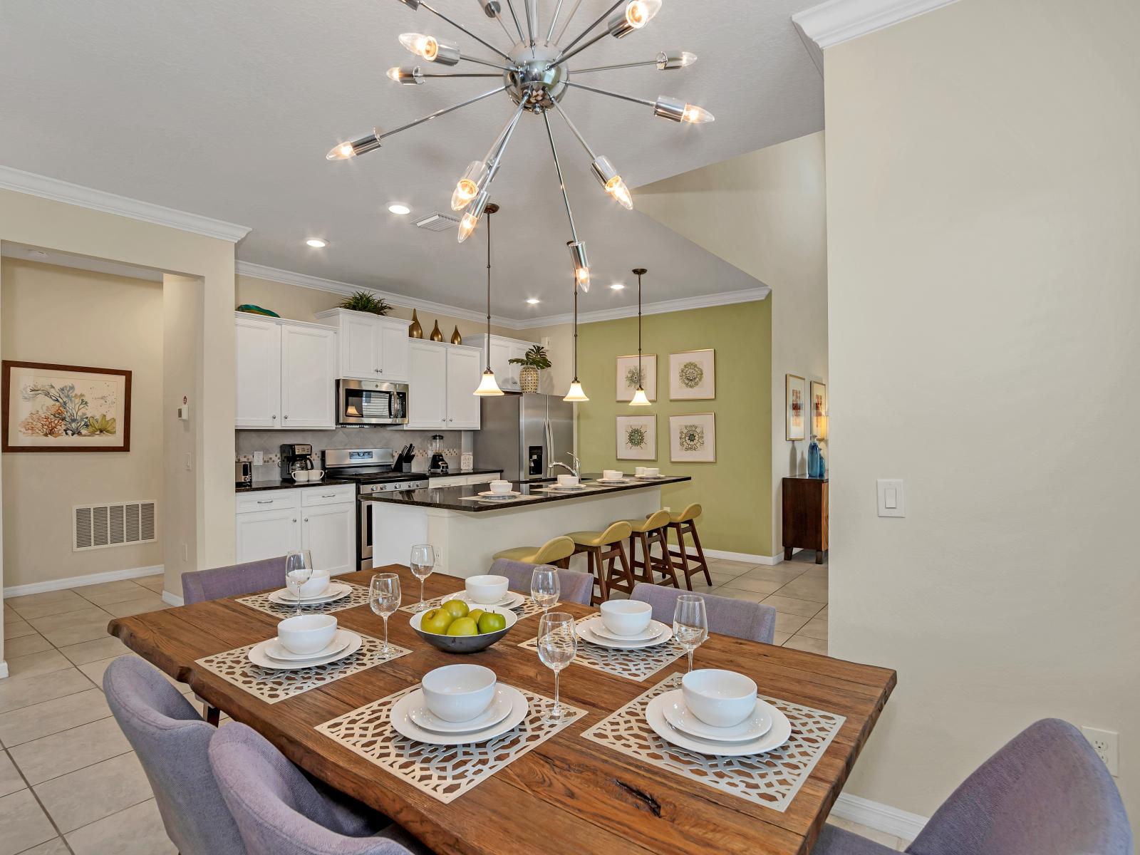 Alluring dining area of the home in Davenport Florida - 6 Persons dining - Chic dining area featuring a stylish table and contemporary seating - Open layout seamlessly connecting the dining area to the kitchen