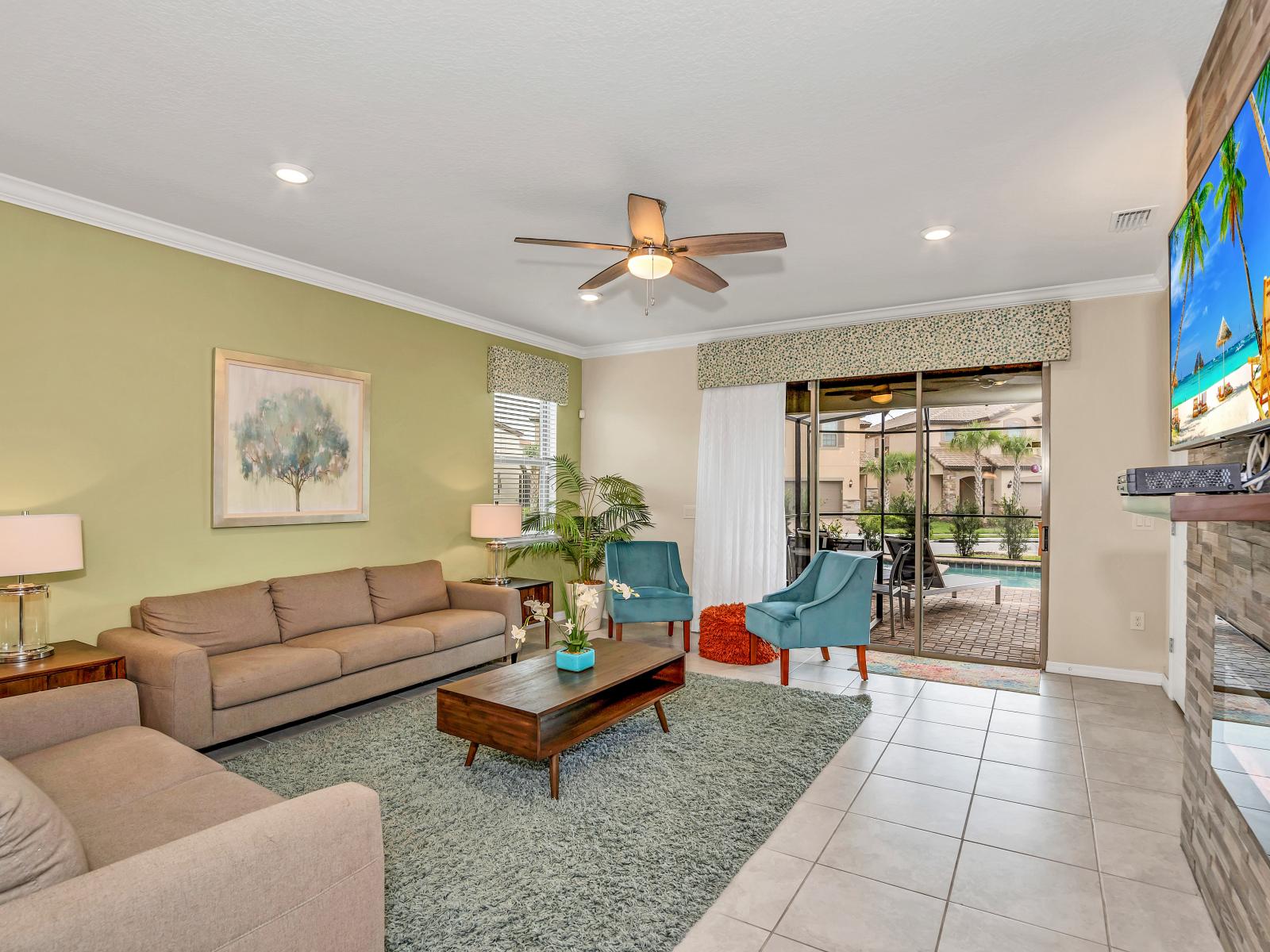 Welcoming living area of the home in Davenport Florida - Elegantly decorated space with a neutral color palette for a timeless appeal - Cozy seating area conducive to relaxation and socializing - Smart TV for entertainment