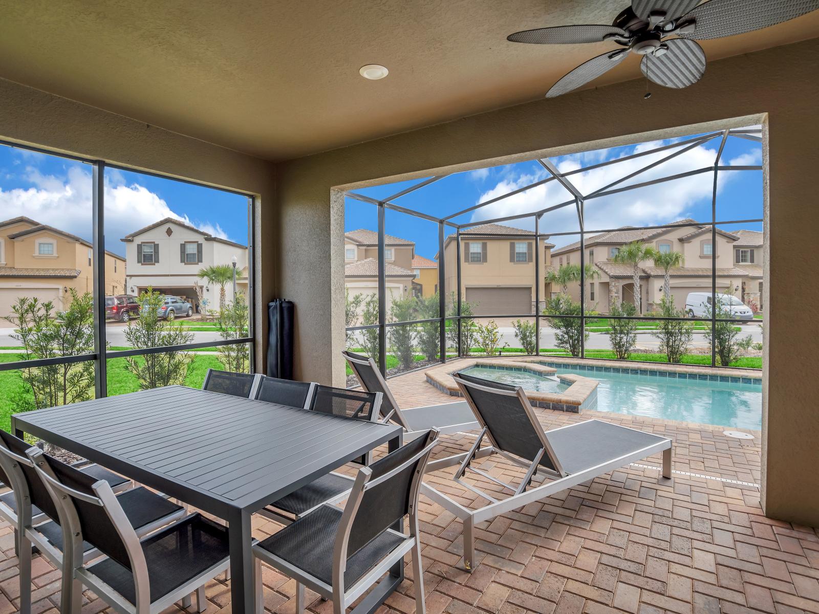 Stunning outdoor dining area of the home in Davenport Florida - Relaxing loungers for soaking up the sun's warm rays - Savor the flavors of paradise with a side of poolside seren - Every meal accompanied by stunning pool views