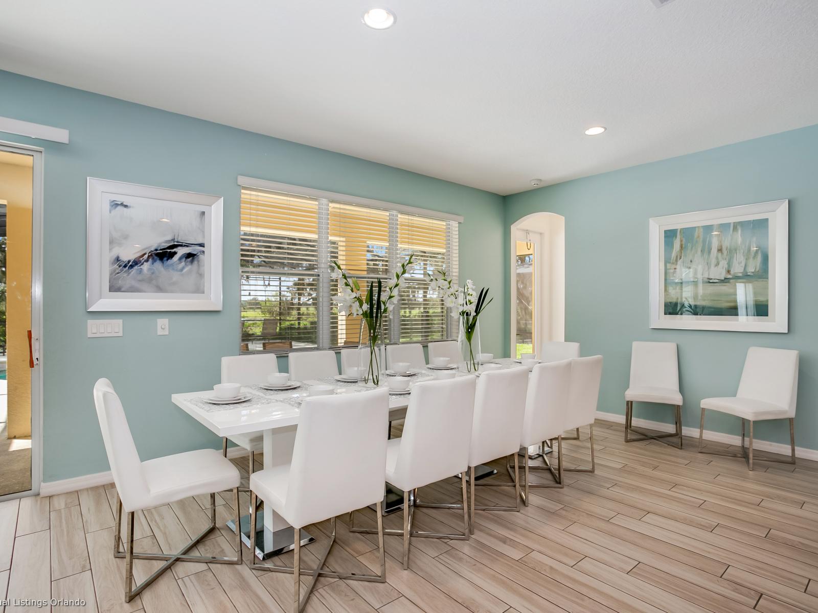 Elevated Dining Area of the Villa in Florida - Sophisticated design with a blend of modern and classic elements - Artfully arranged table settings for a touch of elegance - 12 Persons Dining