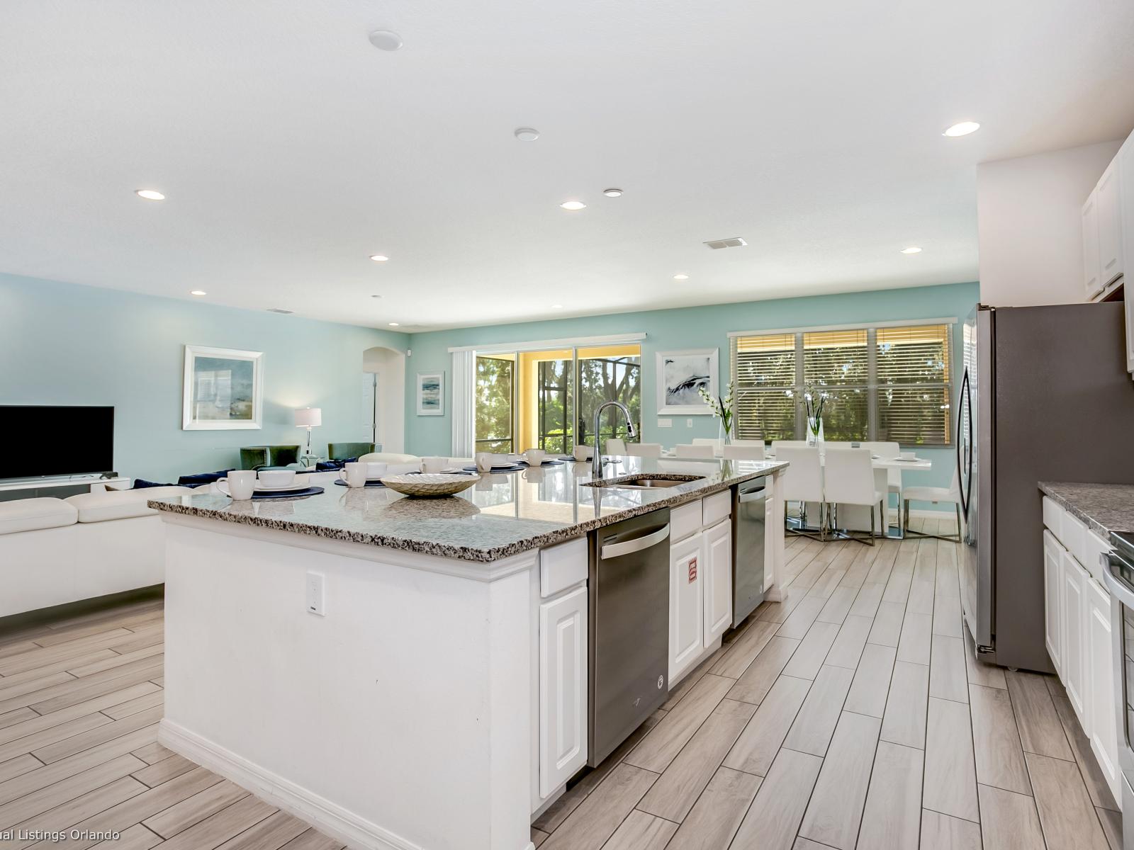 Spacious Kitchen Area of the Villa in  Florida - Modern kitchen with sleek, stainless steel appliances - Contemporary design with clean lines and minimalist aesthetics - Smart use of space with versatile storage solutions