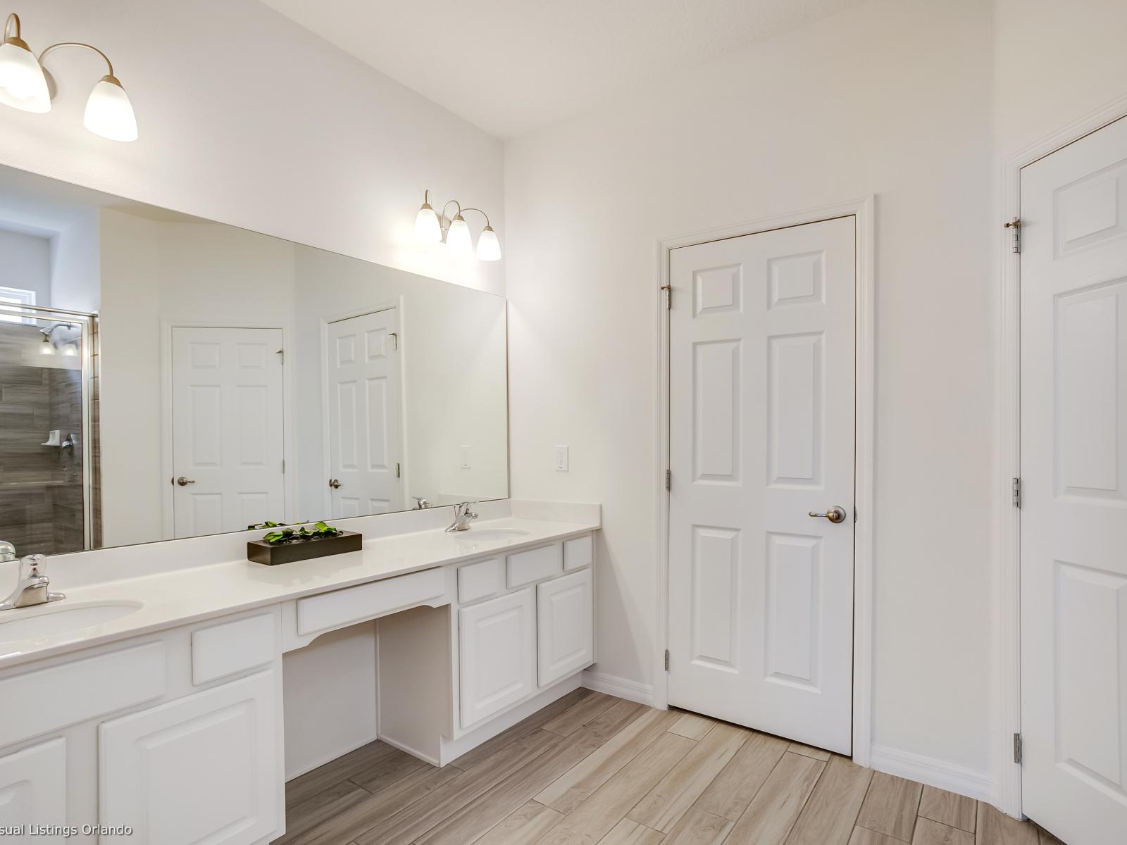 Lavish Bathroom of the Villa in Florida - Polished Dual Vanity with Large Mirror - Elevated Shower Experience - Step into our bathroom with a walk-in shower - Offering a perfect blend of style and convenience