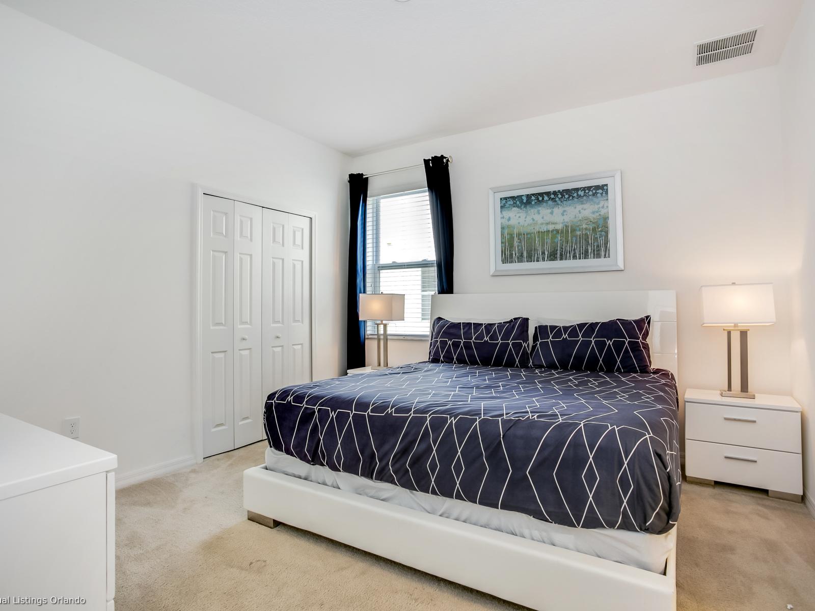 Fanciful Bedroom of the Villa in Davenport Florida - Cozy retreat with a plush bed, perfect for relaxation - Smart use of space with efficient storage solutions - Luxurious bedding for a restful night's sleep