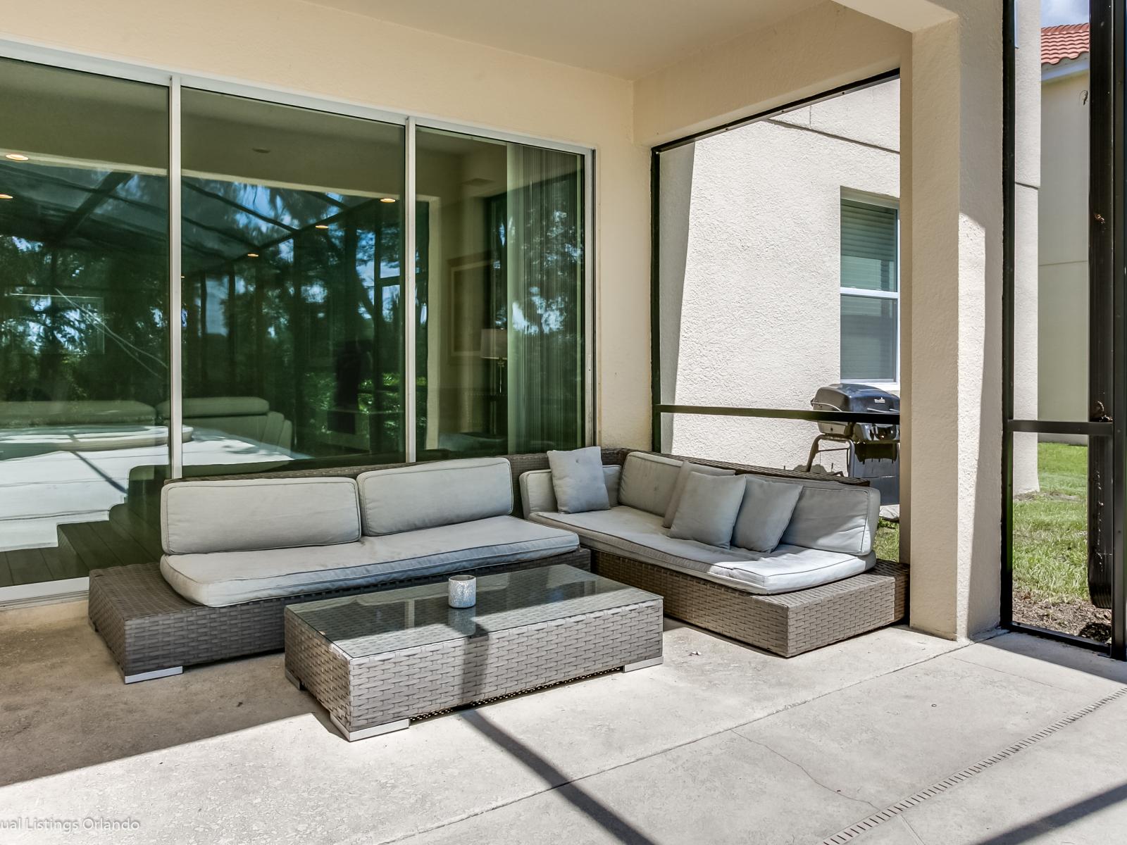 Plush Outdoor seating area of the Villa in Florida - Plush seating arrangements invite relaxation and stylish gatherings - Refreshing Atmosphere - Greenery and natural elements for a fresh and lively feel