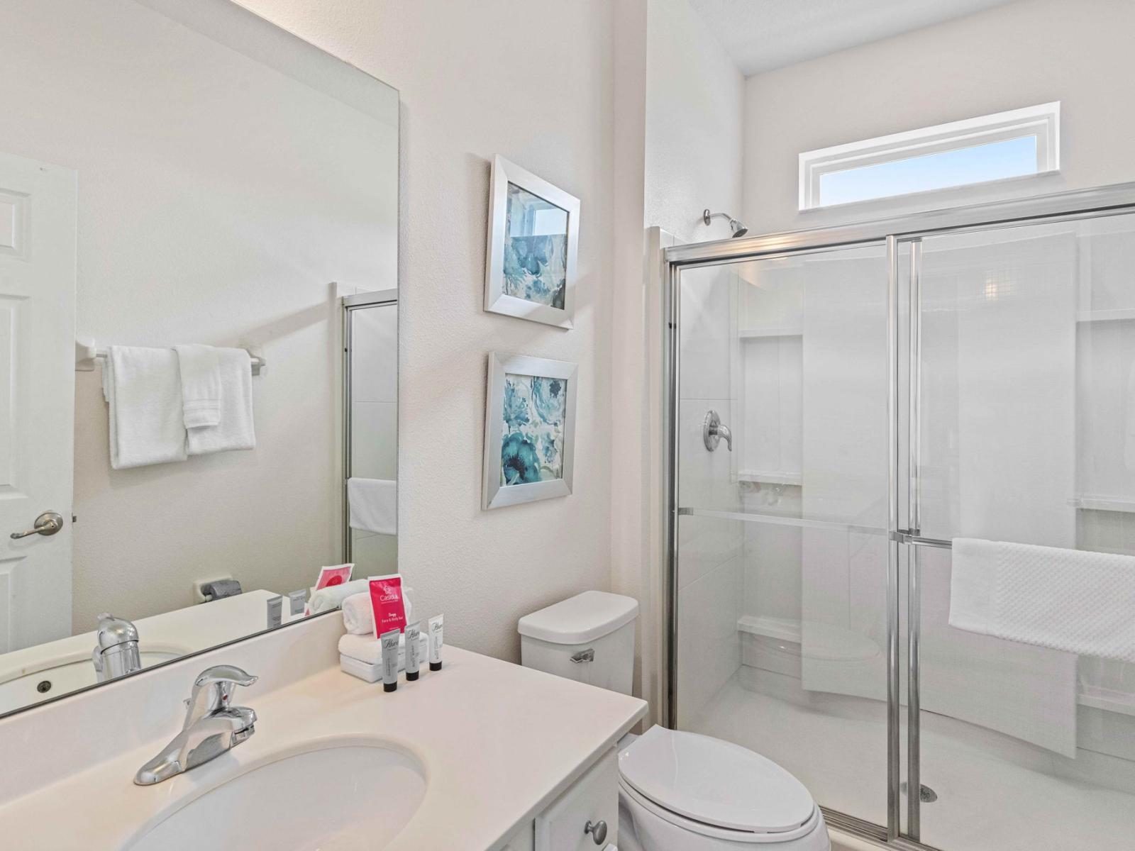 Experience a refreshing shower in the spacious and sleek walk-in design of Bathroom 4.