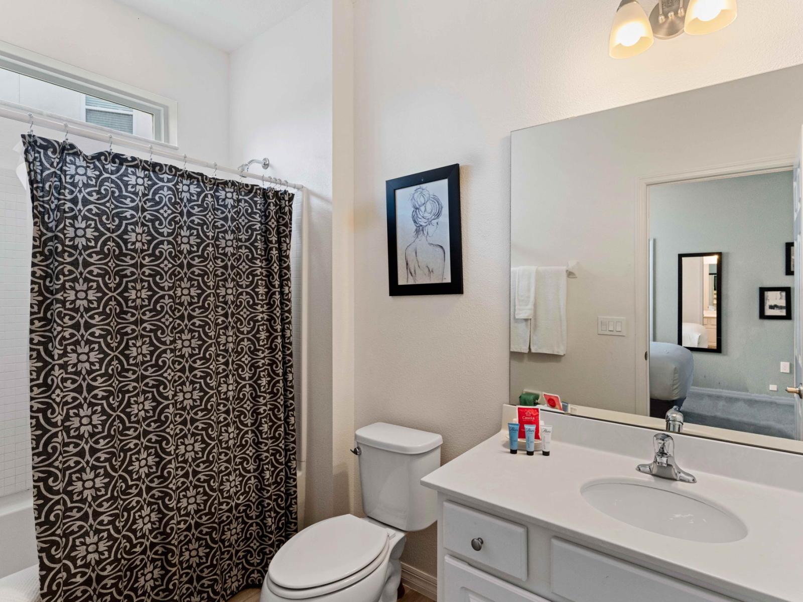 Unwind in style with a relaxing bath or refreshing shower in Bathroom 5’s bathtub and shower combo.