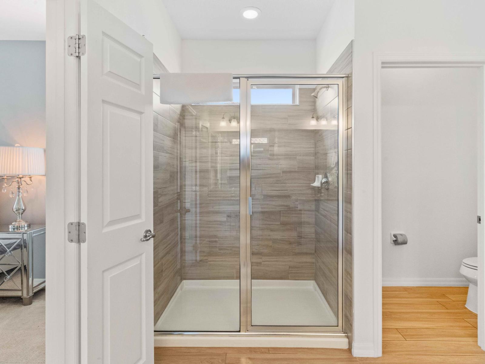 Experience modern comfort with the sleek walk-in shower in Bathroom 7.